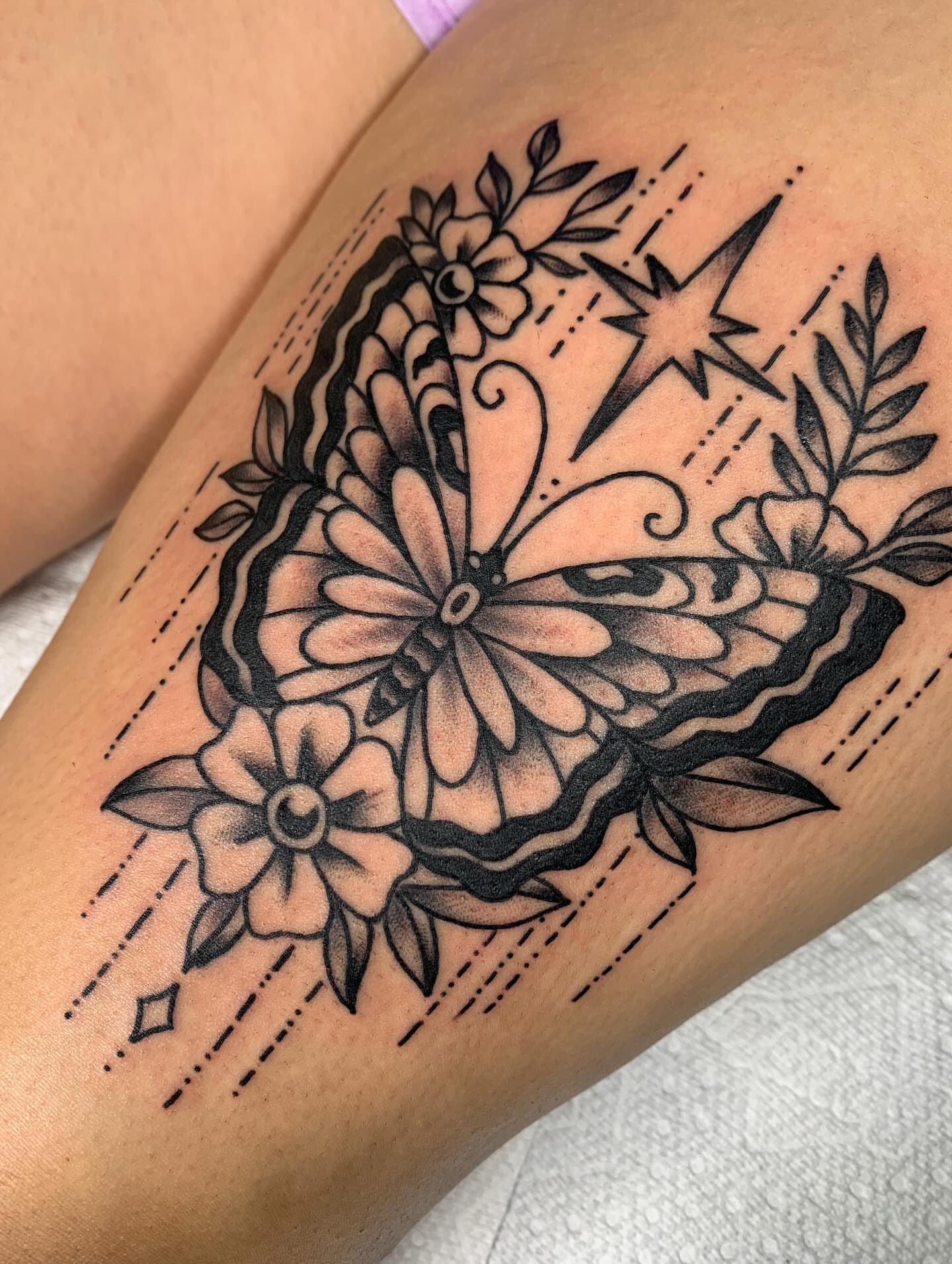 Floral arrangement ornamental tattoo on the thigh by April Morris ⚔️ Tattoo Goblin