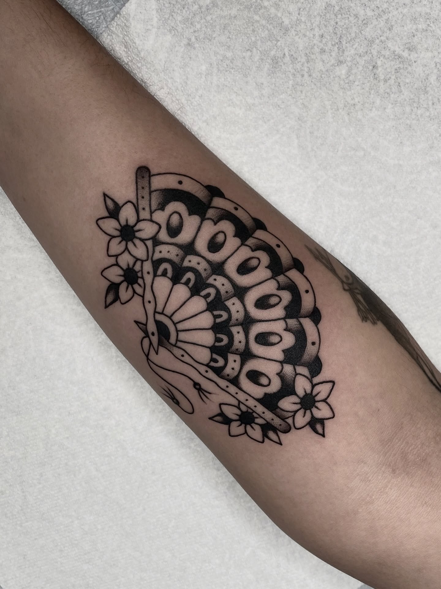 Mandala black and grey tattoo on the forearm by Dakota Jenner