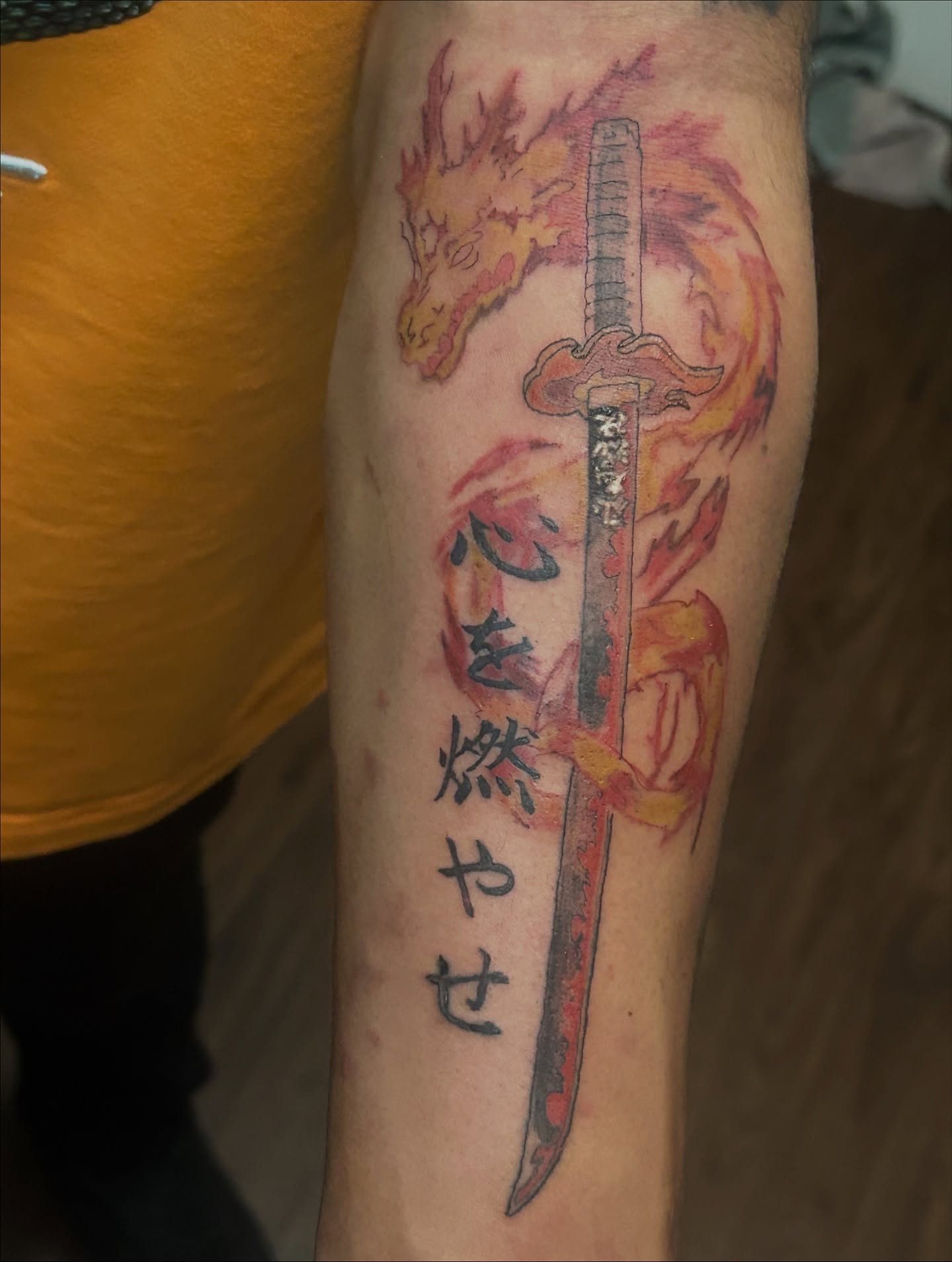 Sword and dragon watercolor tattoo on the forearm by Trae