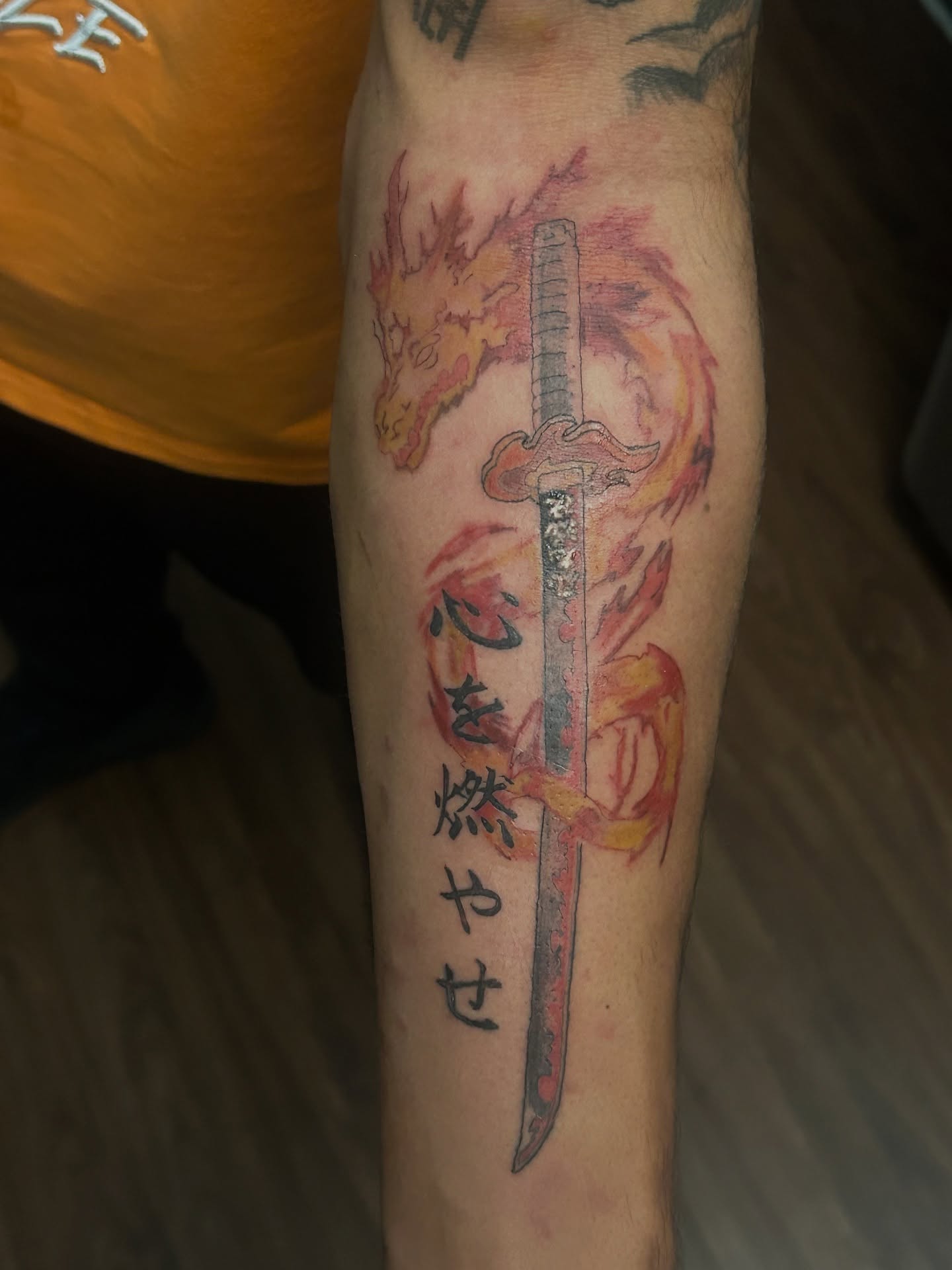 Katana and dragon watercolor tattoo on the forearm by Trae