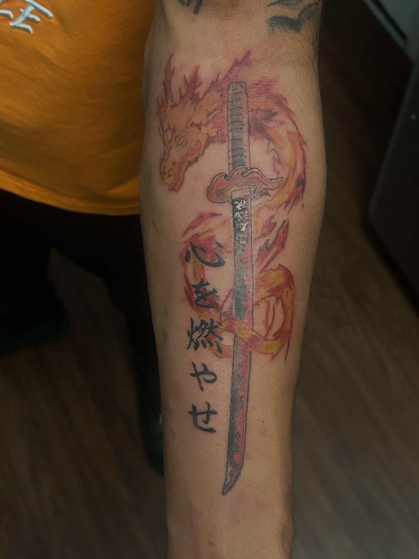 Flaming sword watercolor tattoo on the forearm by Trae