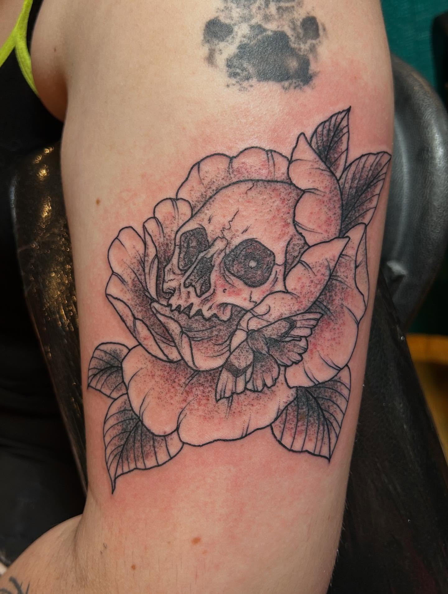 Skull and rose with moth dotwork tattoo on the forearm by Jaime Gaiti
