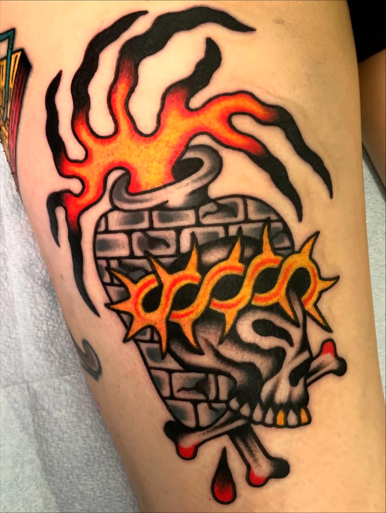 Burning skull American traditional tattoo on the thigh by Julia Louise