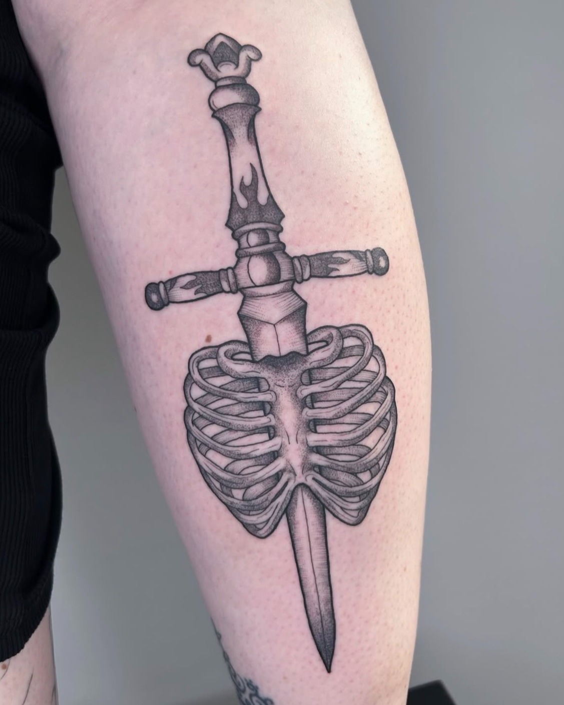 Skeleton ribcage black and grey tattoo on the forearm by Poppy Olivia Deards