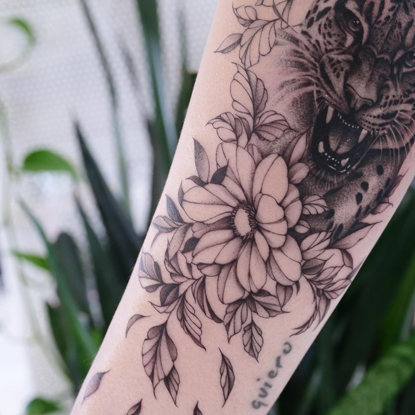 Jaguar and flowers realism tattoo on the forearm by Raytattooist