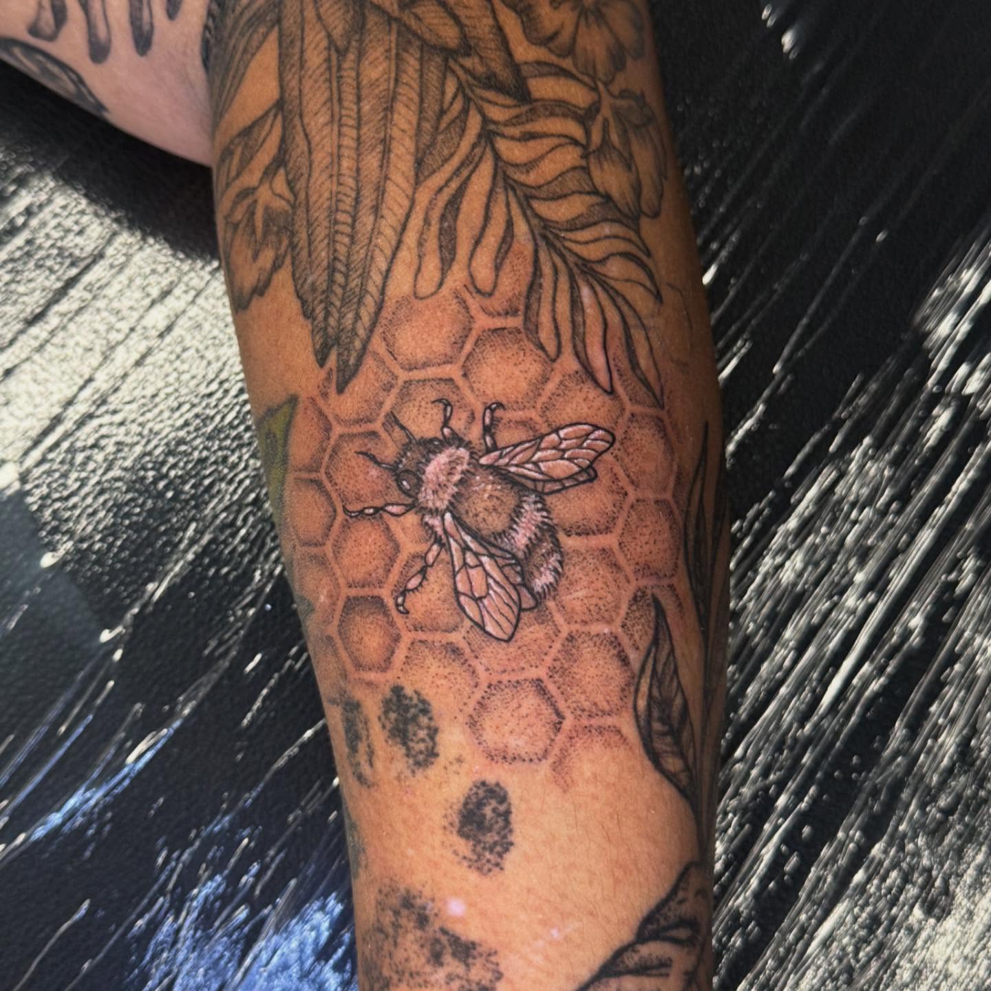 Bee and honeycomb dotwork tattoo on the forearm by Tyla Pistak, Seattle, Washington