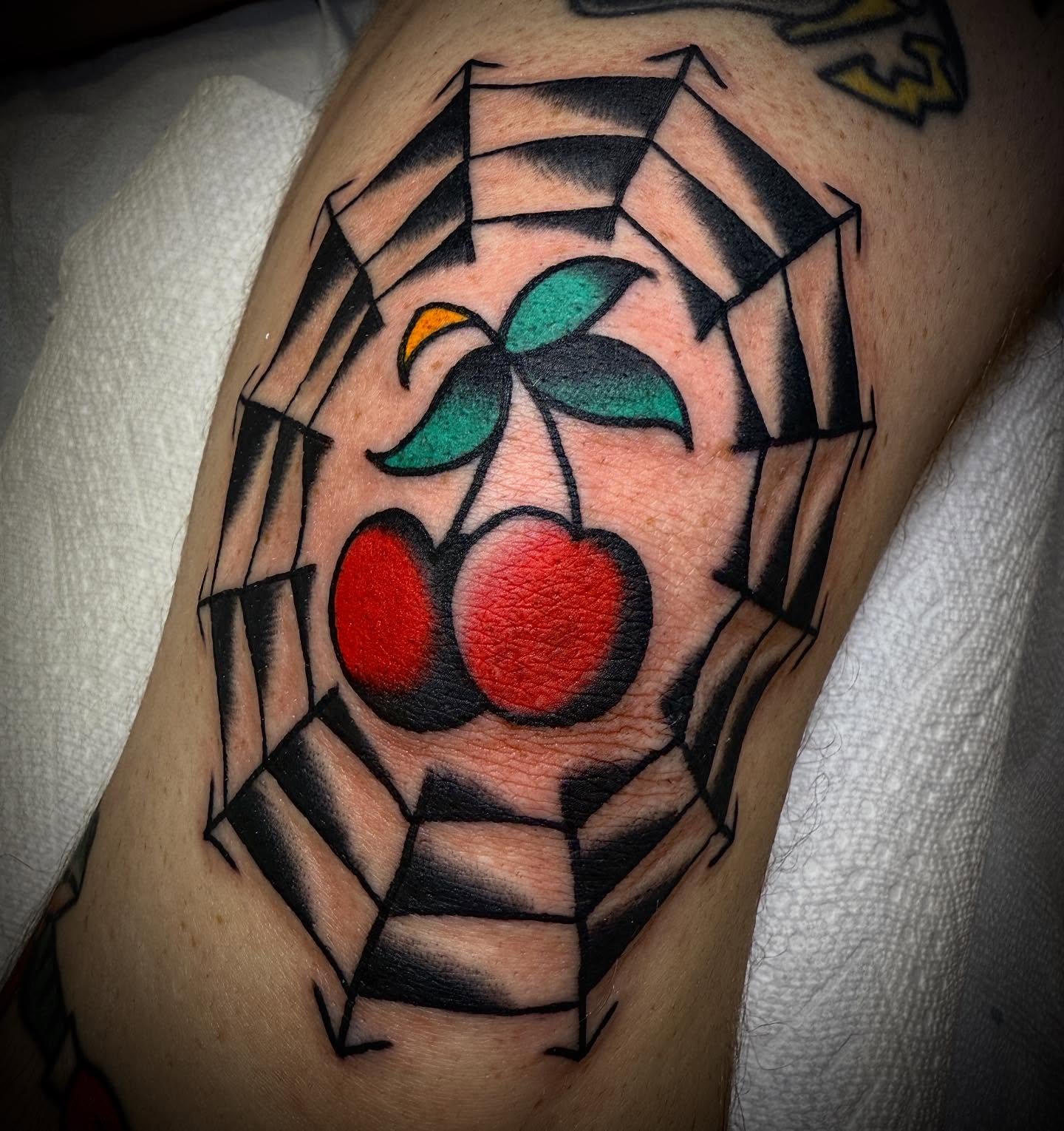 Cherry American traditional tattoo on the forearm by Tristan Bradshaw