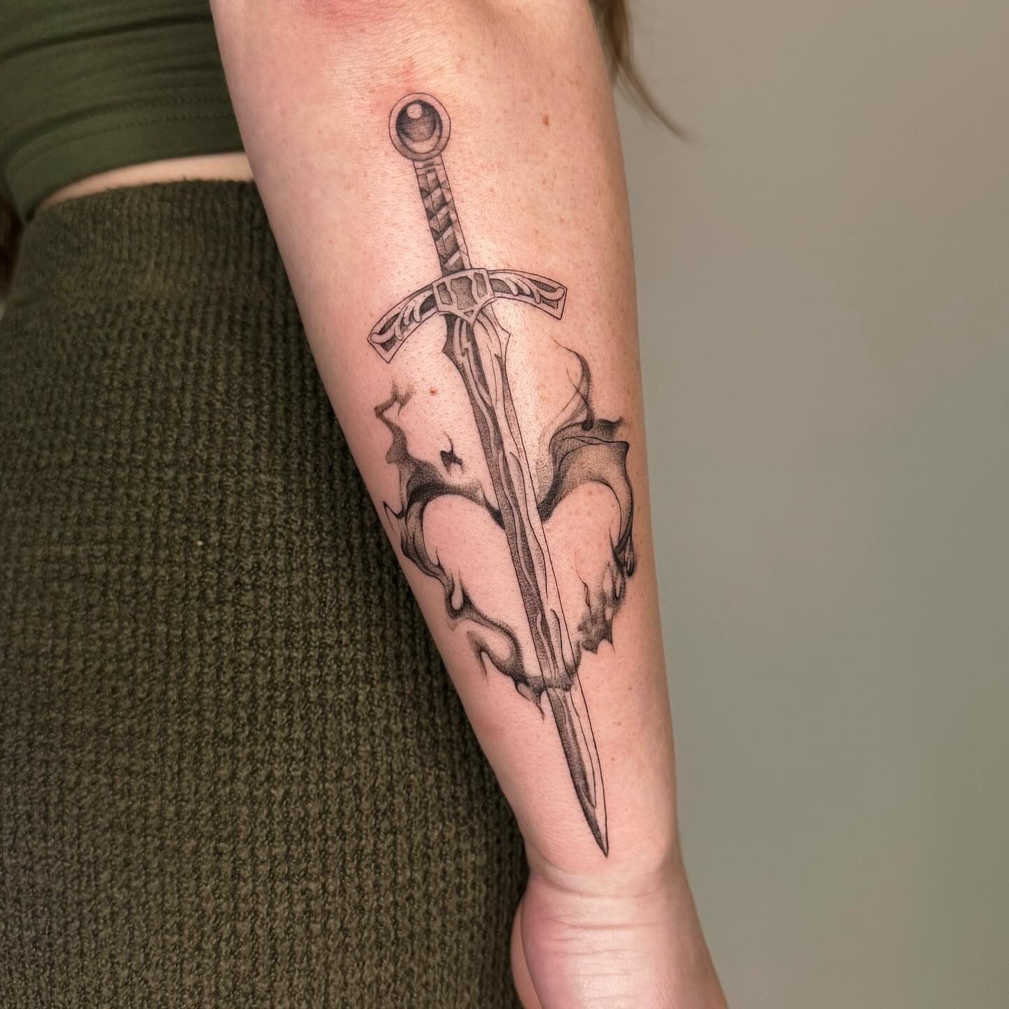 Sword black and grey tattoo on the forearm by Alyssa . Villela