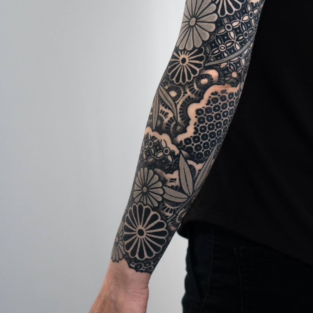 Floral and geometric patterns geometric tattoo on the forearm by Kevin Ligabue
