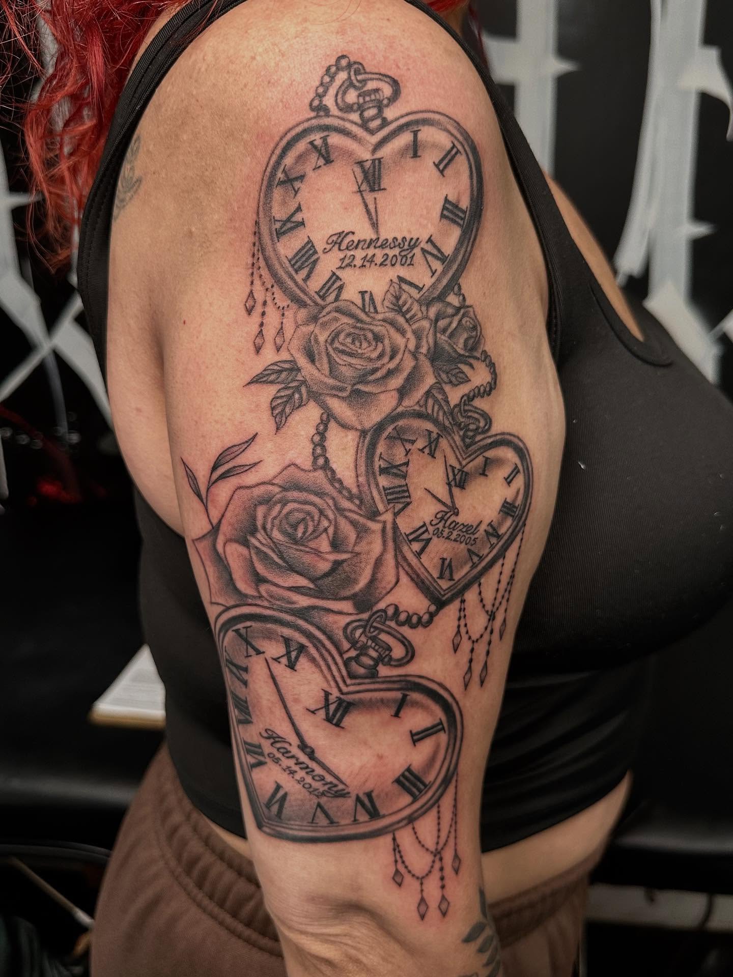 Clocks and roses realism tattoo on the upper arm by Kimberly landin