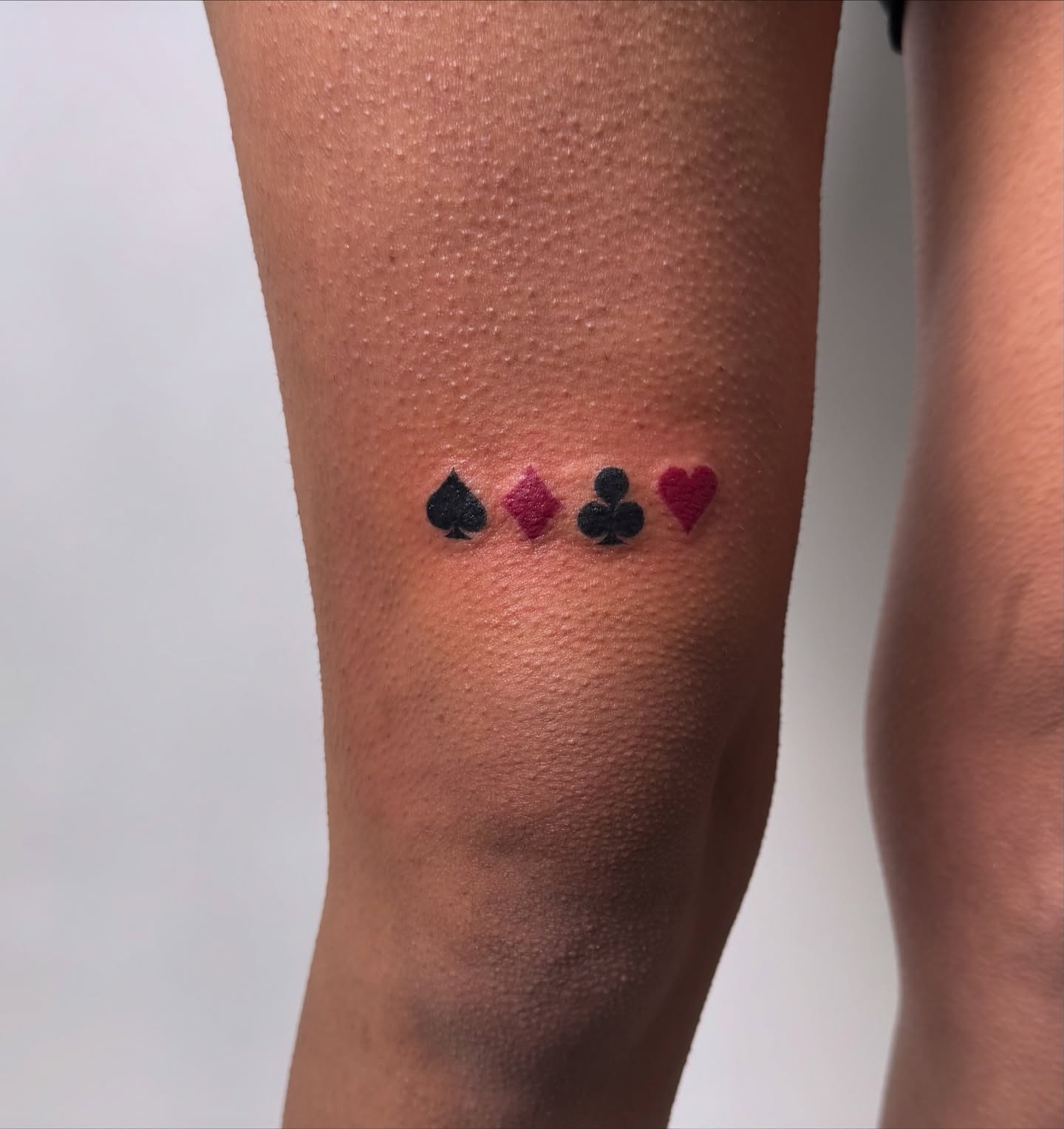 Playing card symbols dotwork tattoo on the forearm by sabina