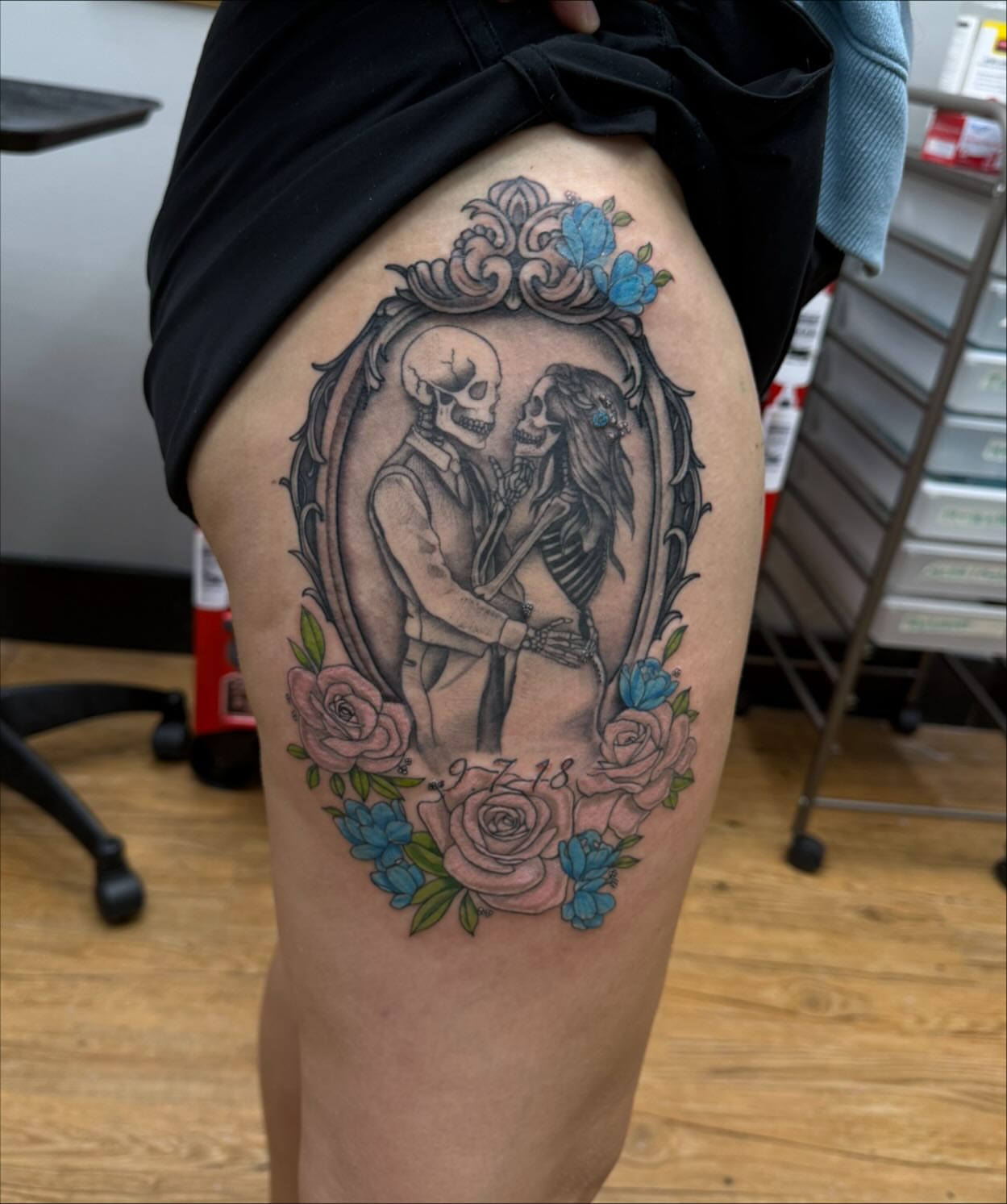 Skeleton couple black and grey tattoo on the thigh by Emmy