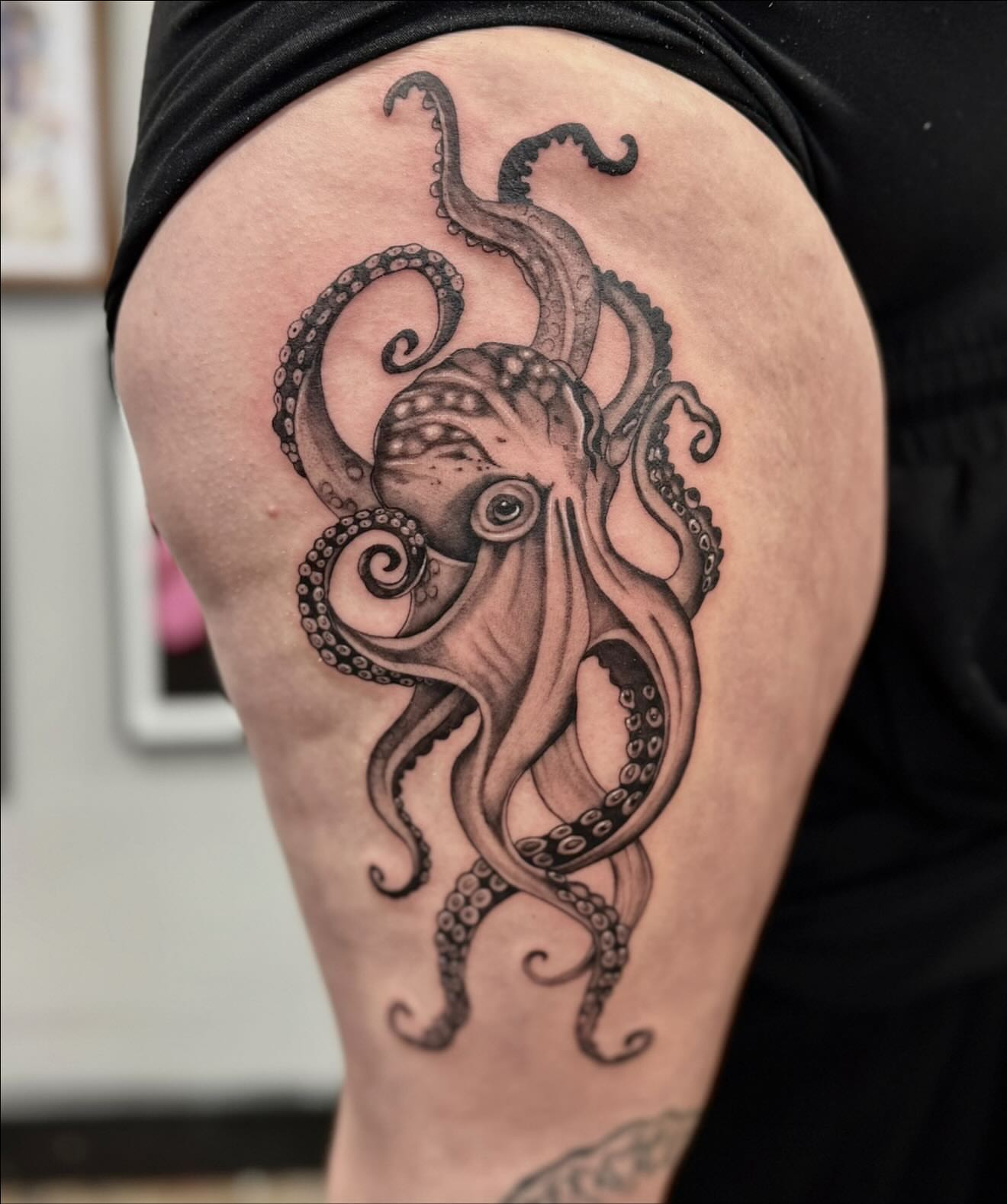 Octopus realism tattoo on the thigh by Emmy