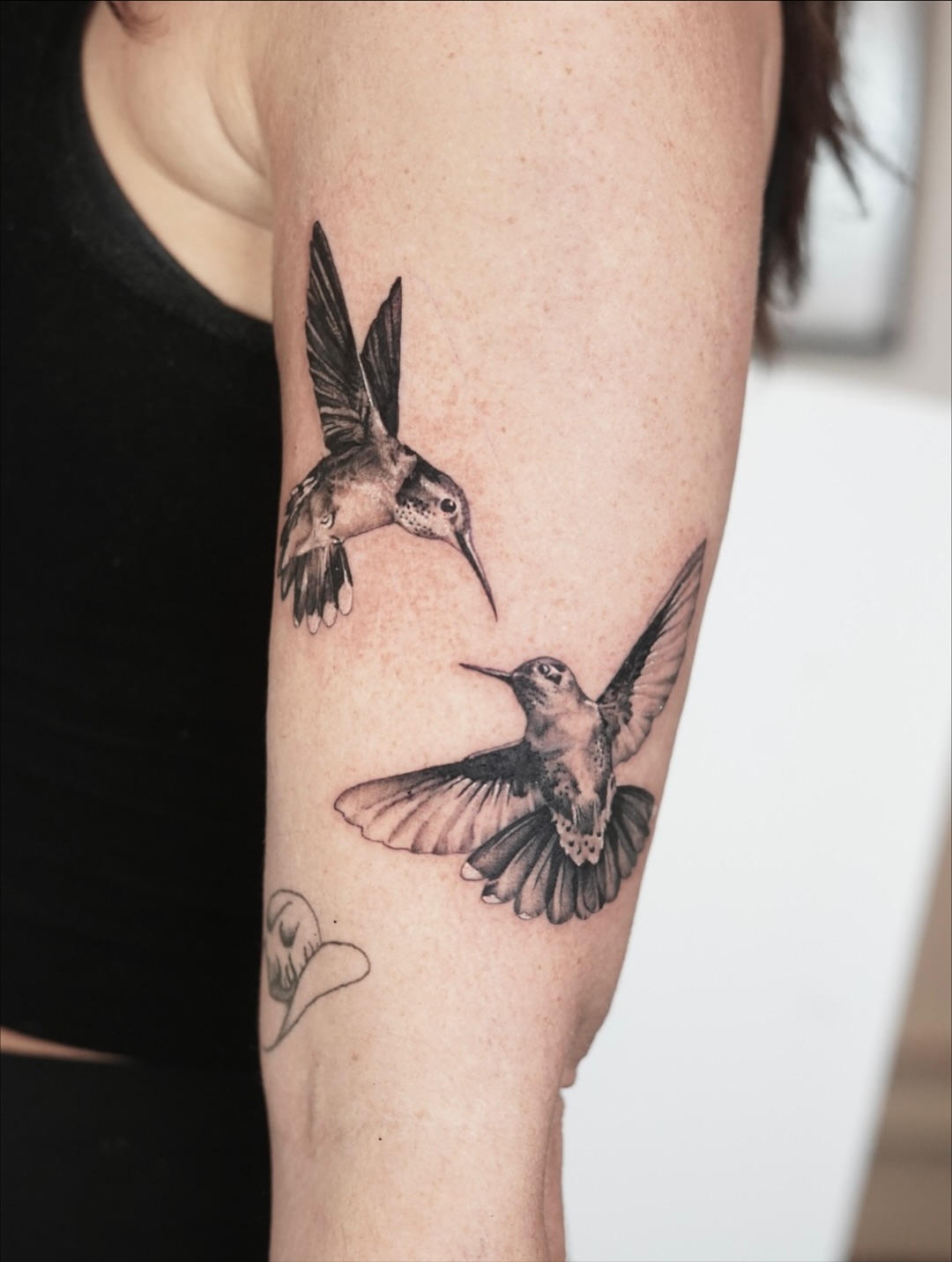 Hummingbirds realism tattoo on the forearm by Tate Wortham