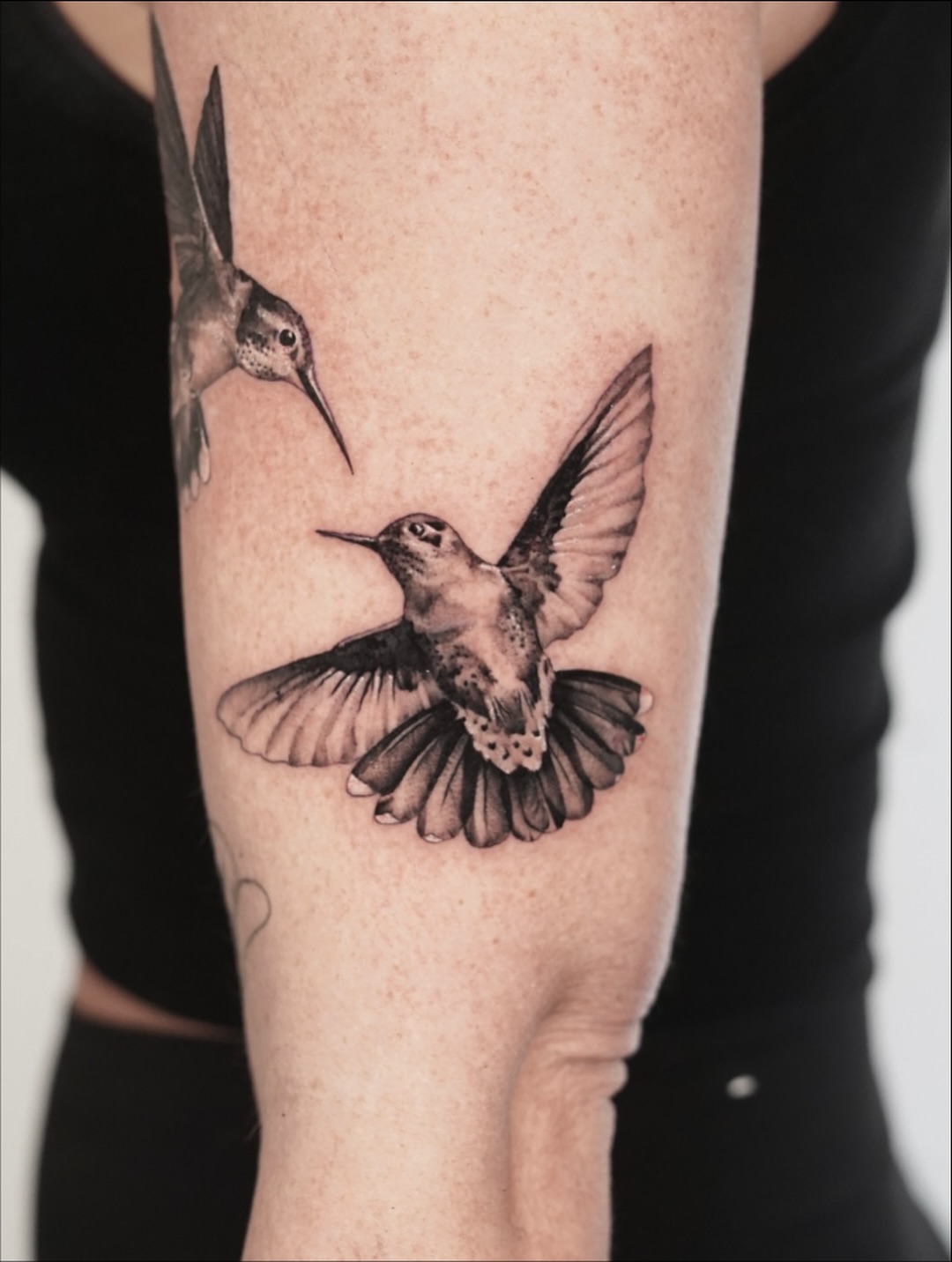 Hummingbirds realism tattoo on the forearm by Tate Wortham