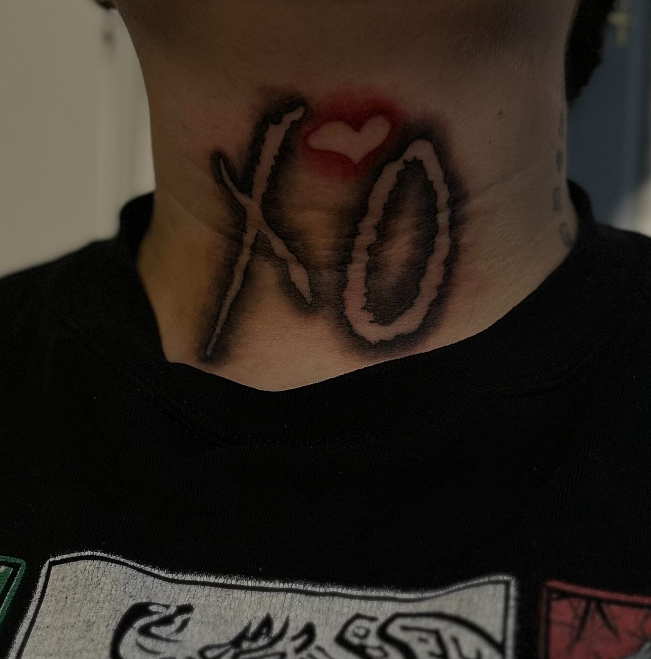 XO with heart black and grey tattoo on the neck by Ink’d by Reina 🖤, Colorado Springs, Colorado