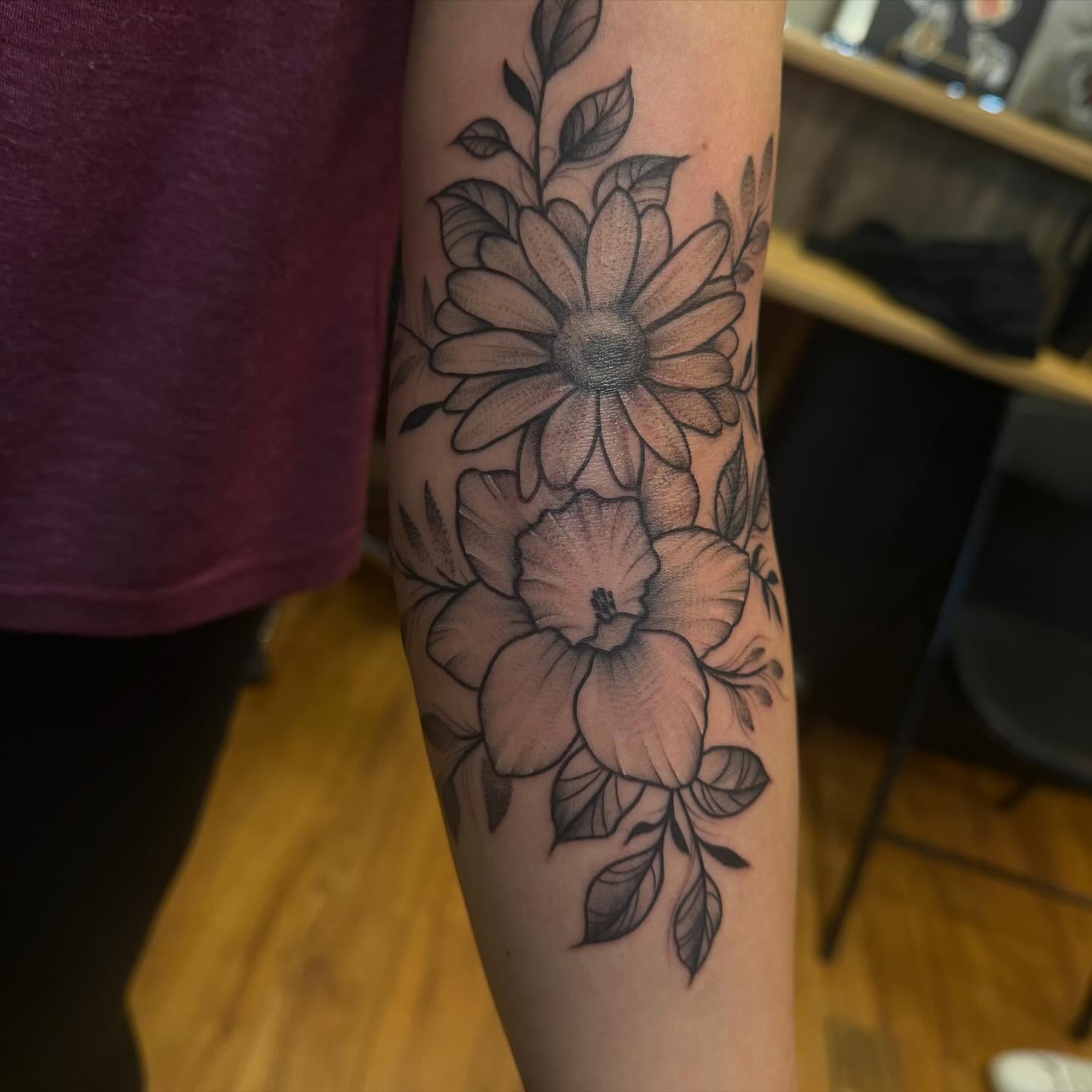 Flowers black and grey tattoo on the forearm by Madilynn Klassen