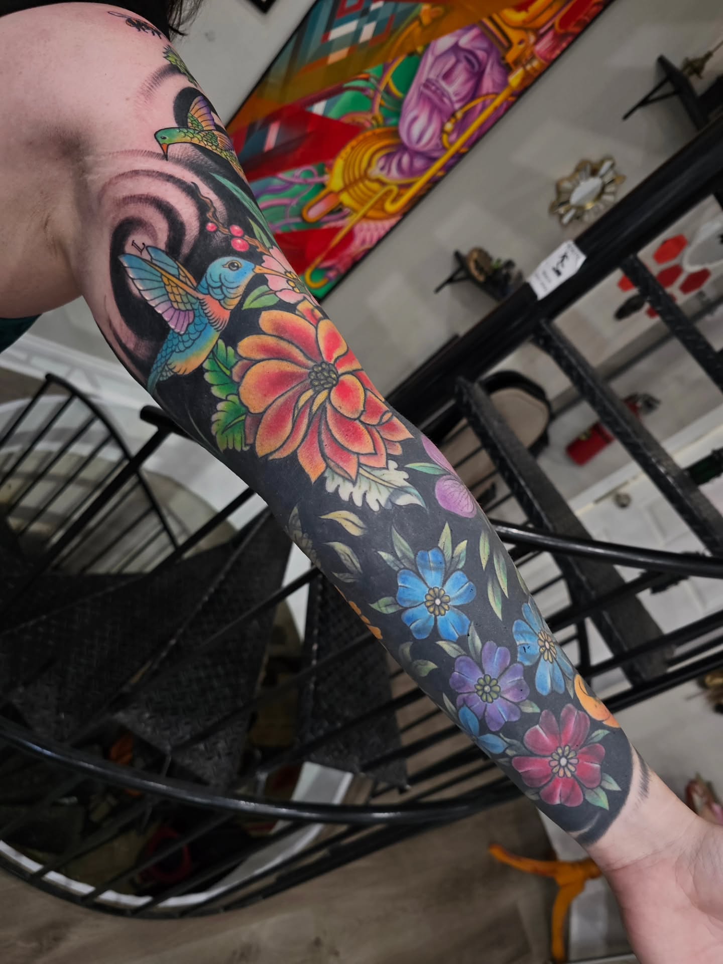 Floral and bird new school tattoo on the upper arm by Shannon