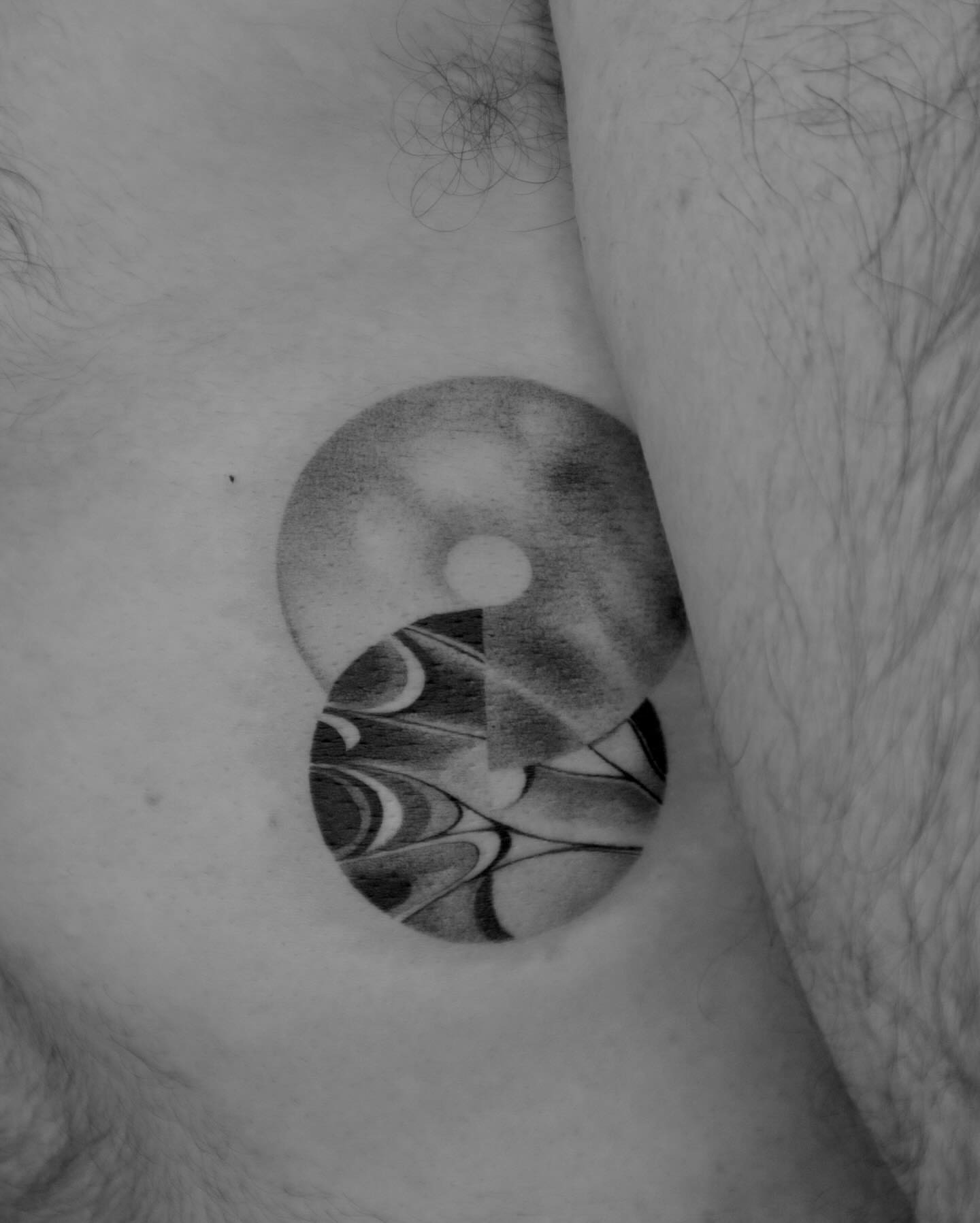 Yin-yang symbol geometric tattoo on the thigh by River, New York, New York