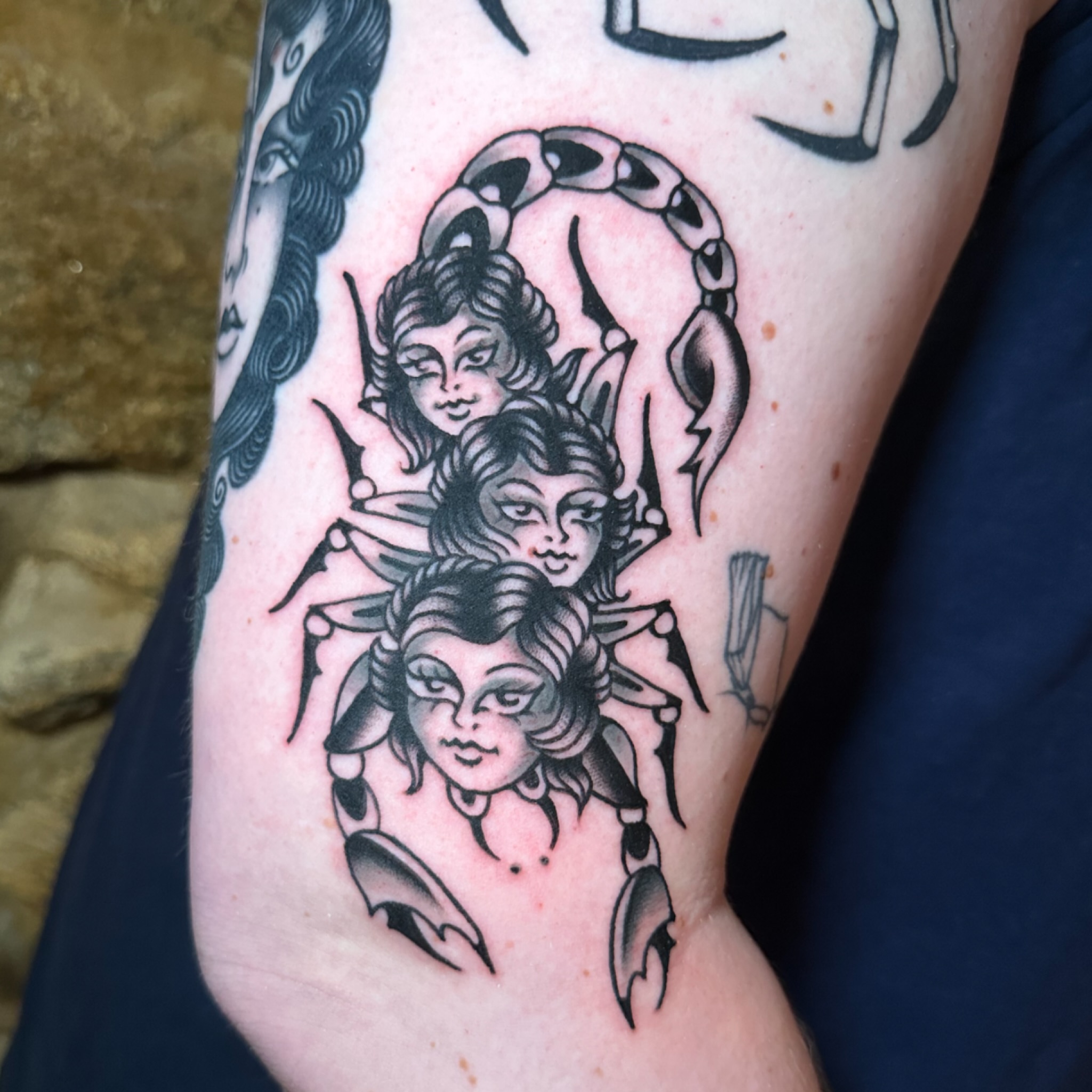 Three-headed woman black and grey tattoo on the forearm by kira