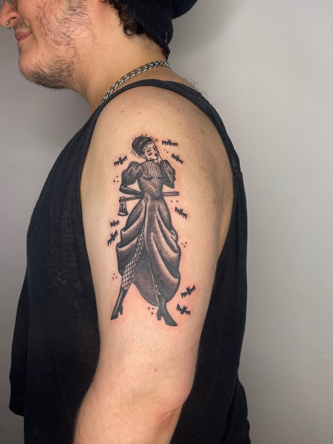 Woman with axe and bats realism tattoo on the shoulder by Fin :