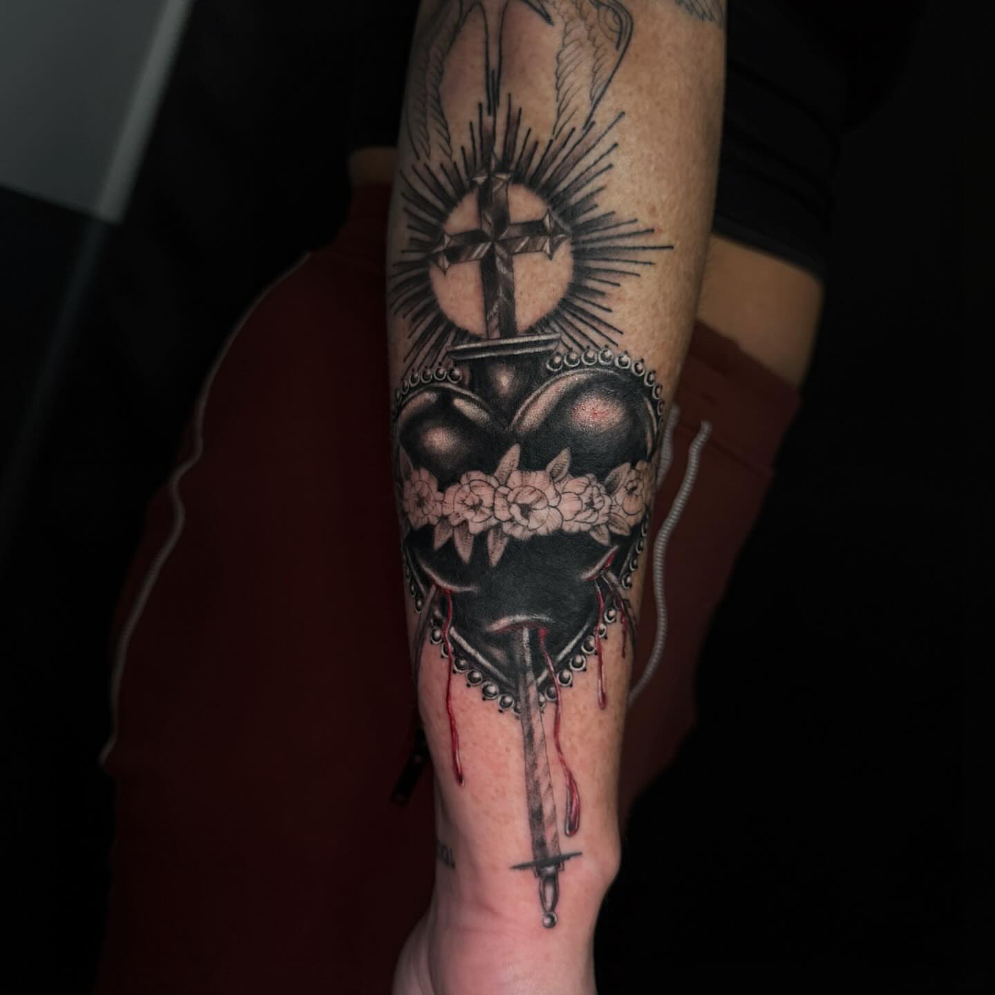Heart pierced by dagger American traditional tattoo on the forearm by Jacie Aasen-Lupino