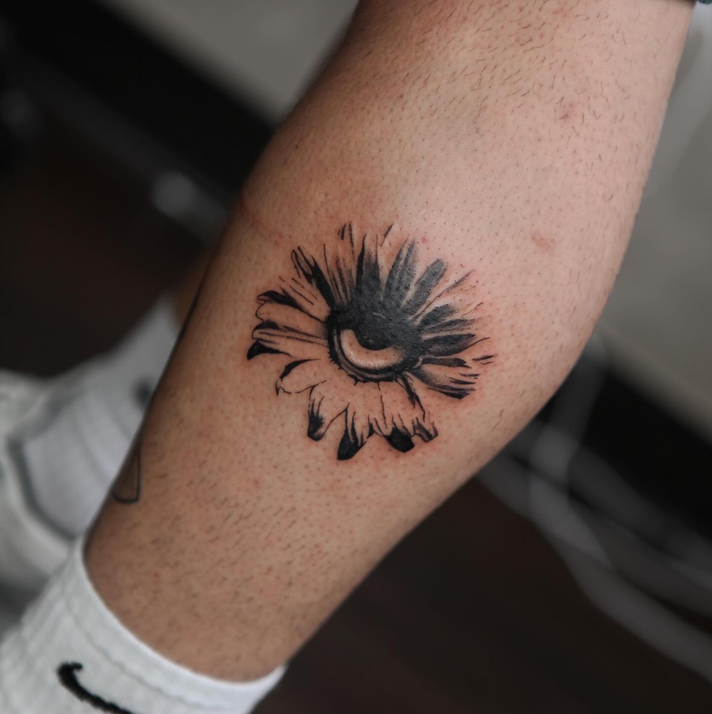 Sunburst black and grey tattoo on the forearm by Liv