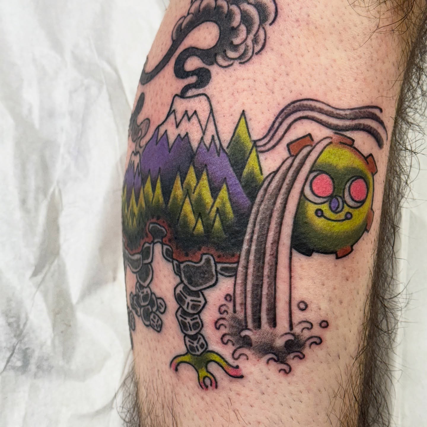 Volcano and creature American traditional tattoo on the forearm by Chris Orta