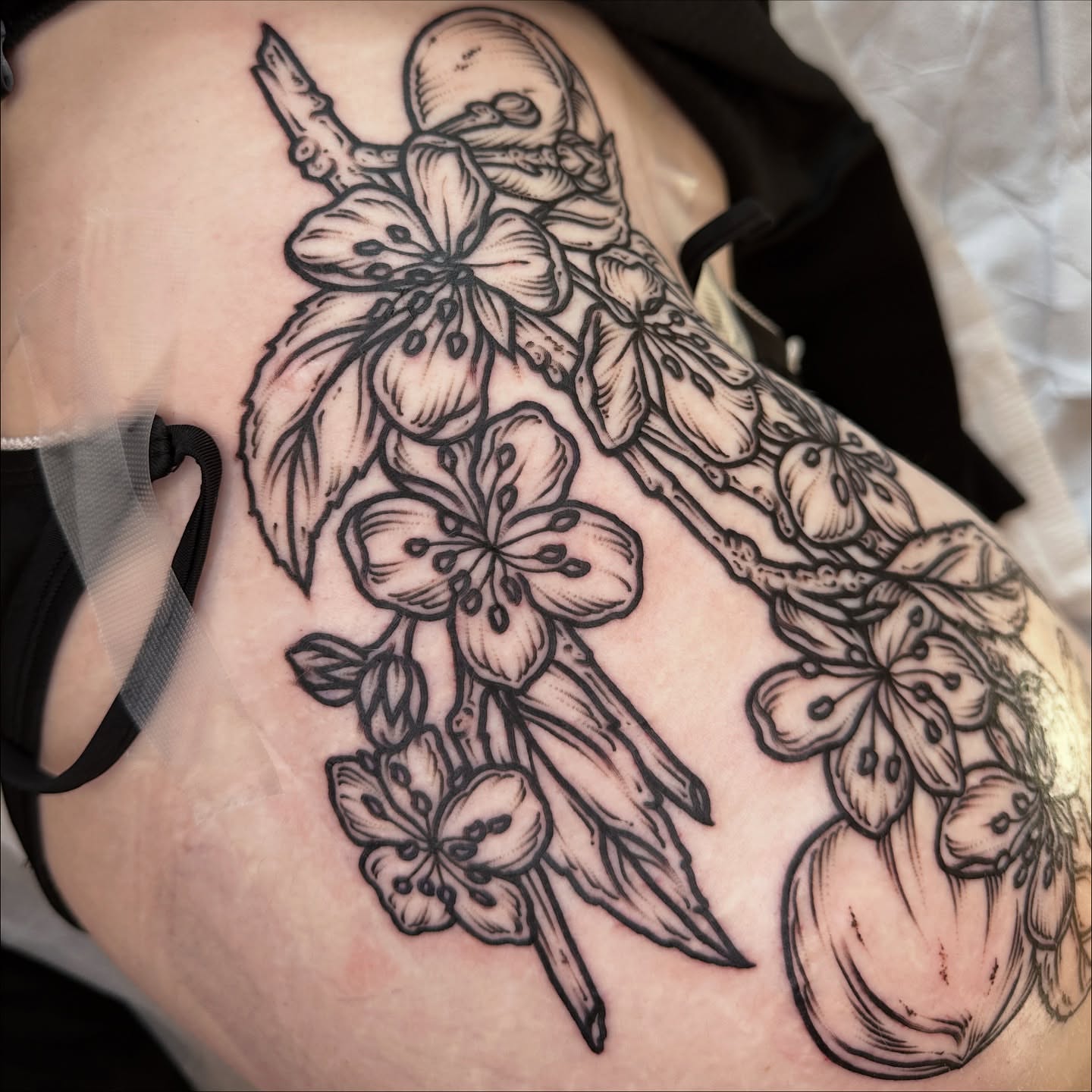 Cherry blossoms black and grey tattoo on the thigh by rosalie