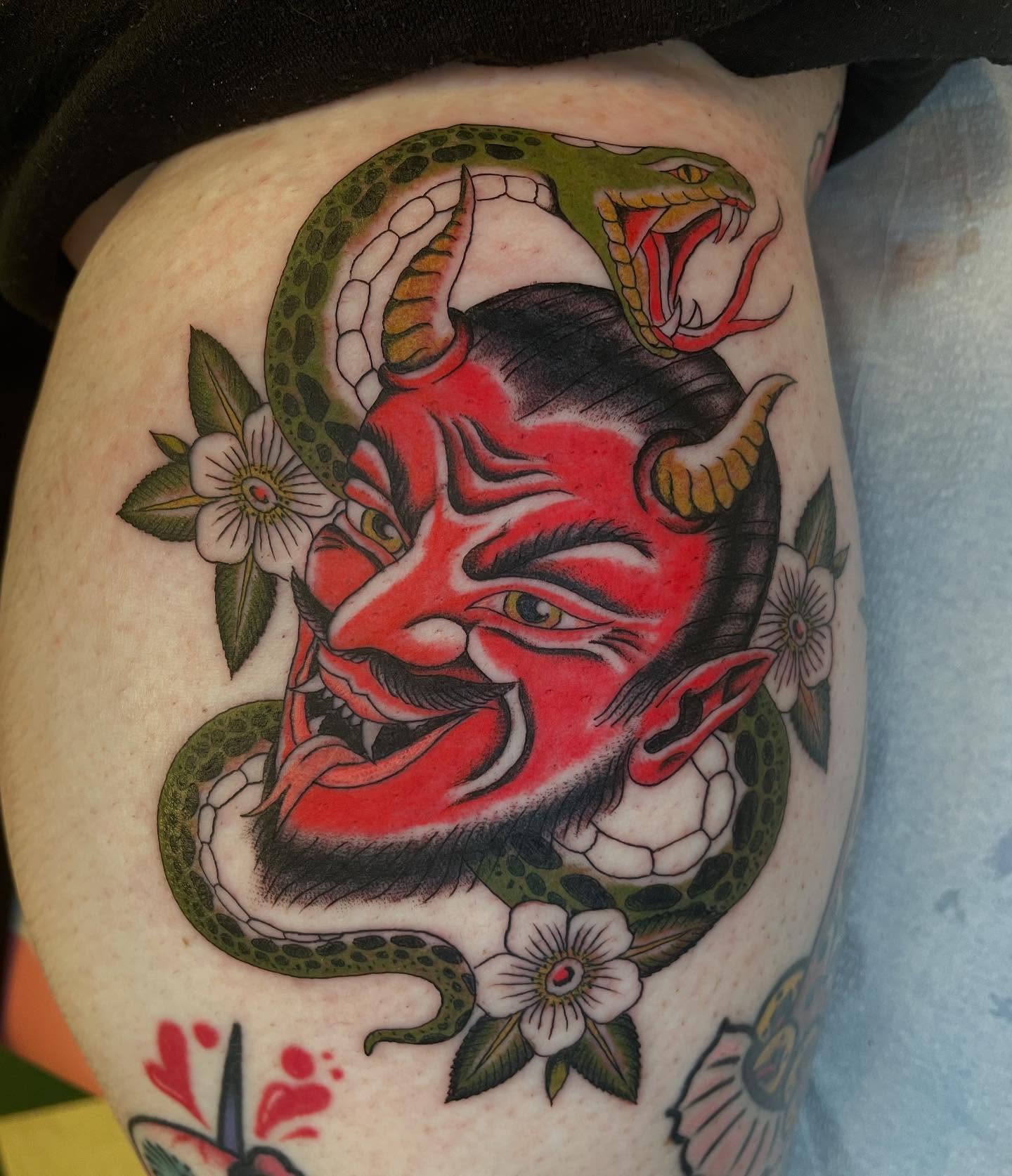 Demon face with snake American traditional tattoo on the thigh by Dayton Tattoo Artist, Miamisburg, Ohio