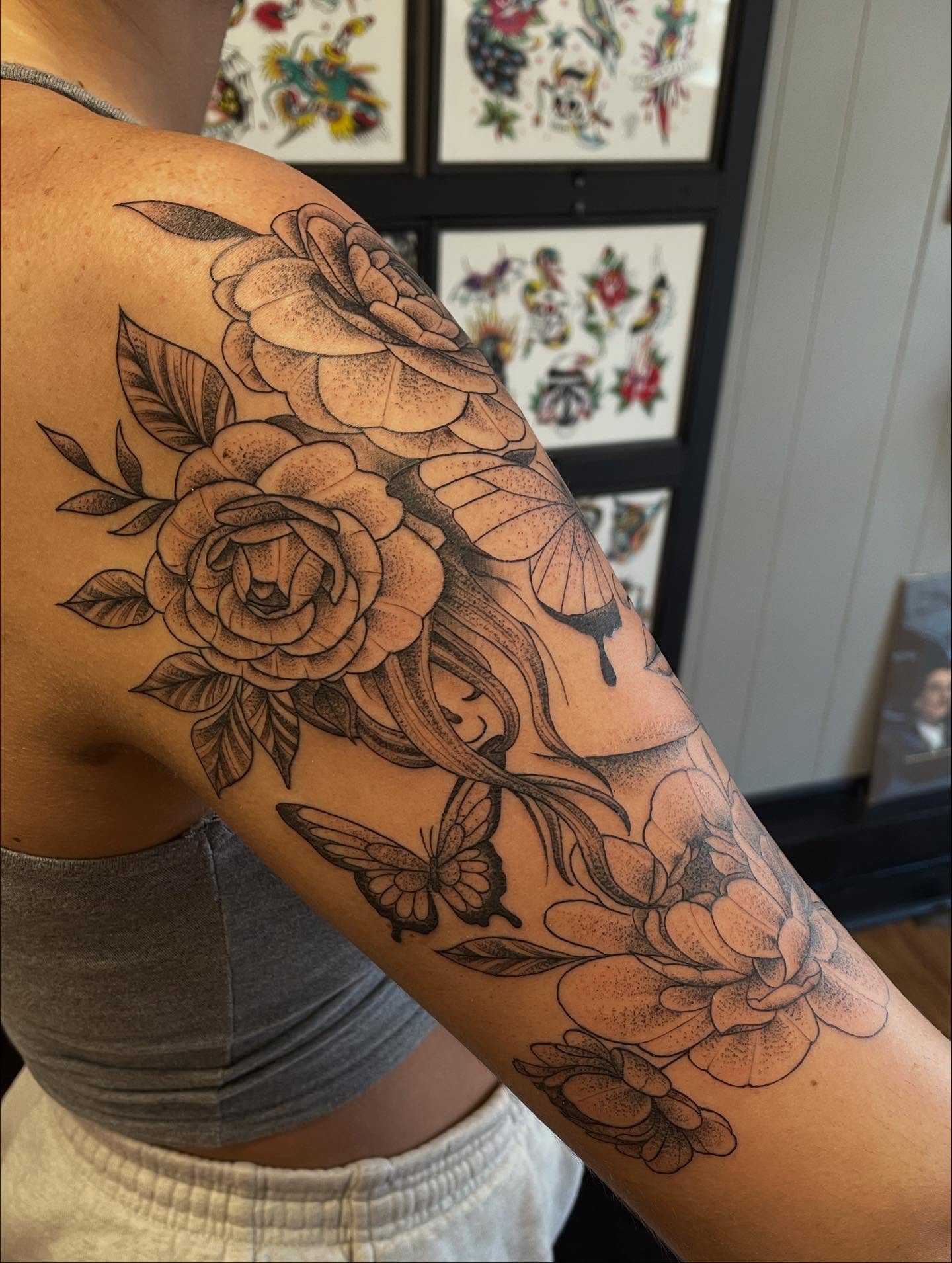Flowers and butterflies black and grey tattoo on the upper arm by Andres Patino 🇪🇨🇺🇸