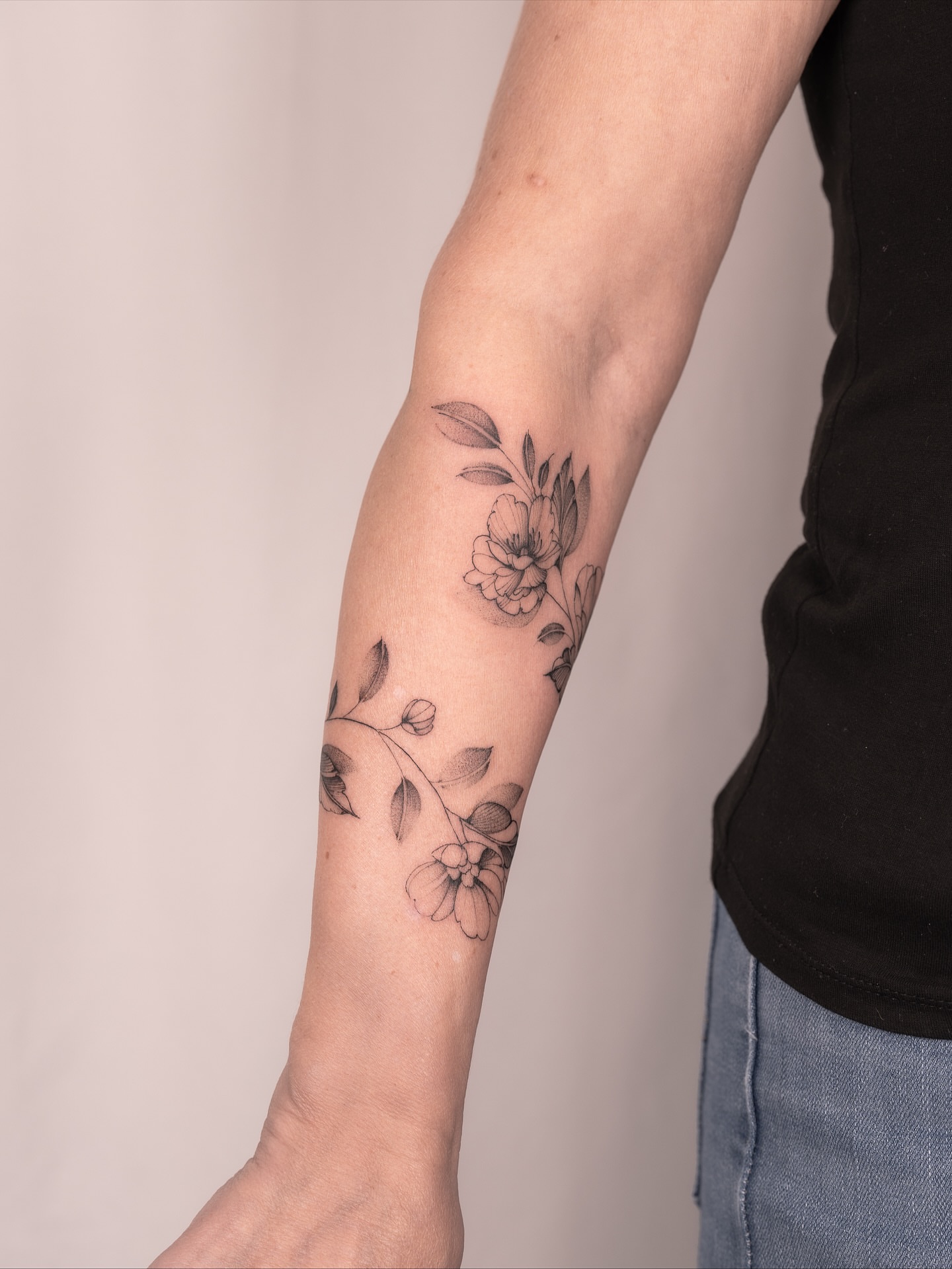 Floral arrangement black and grey tattoo on the forearm by Leo Gao