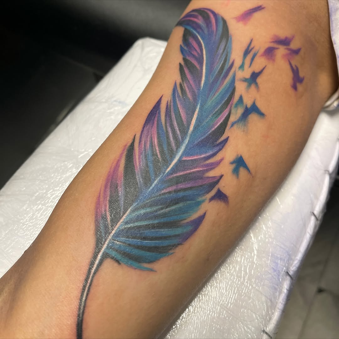 Feather and birds watercolor tattoo on the forearm by Jayme
