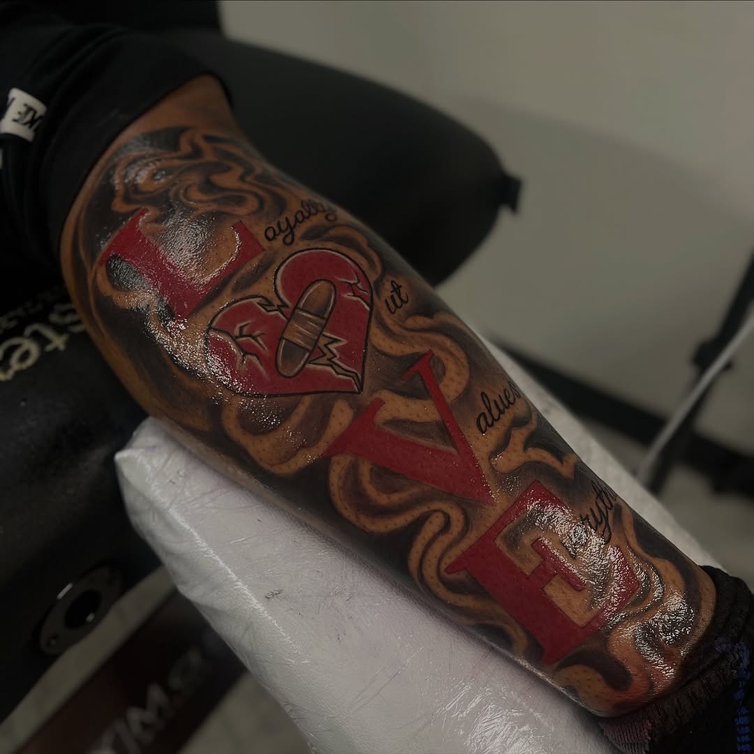 LOVE with broken heart realism tattoo on the forearm by Jayme