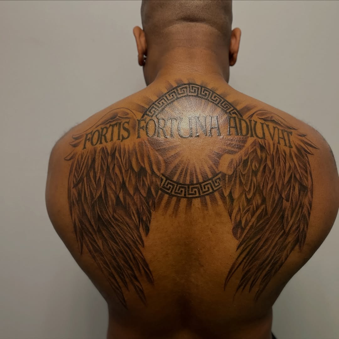 Wings and latin phrase realism tattoo on the back by Jayme