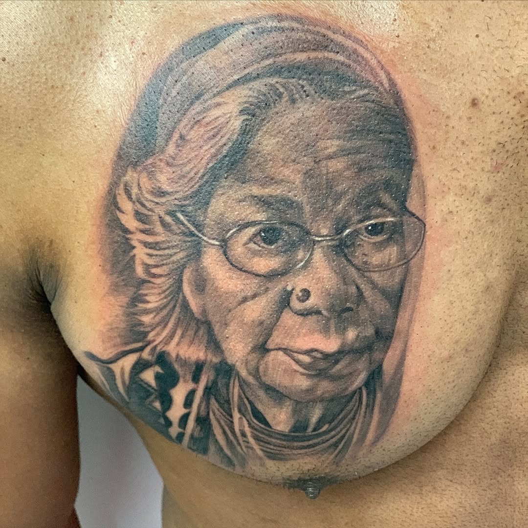 Portrait of an elderly woman Chicano tattoo on the chest by Jayme