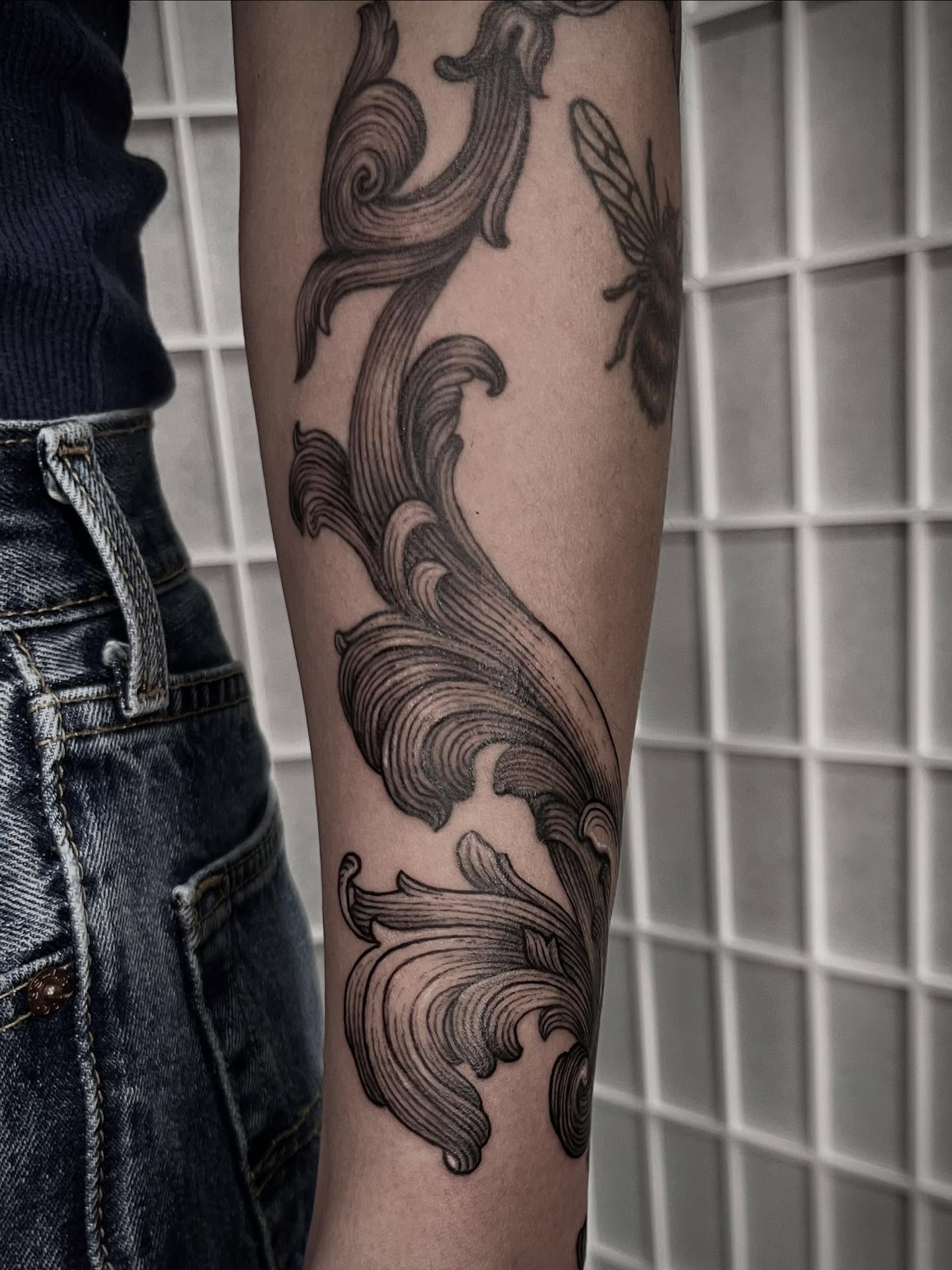 Scrollwork black and grey tattoo on the forearm by Tattoo Artist