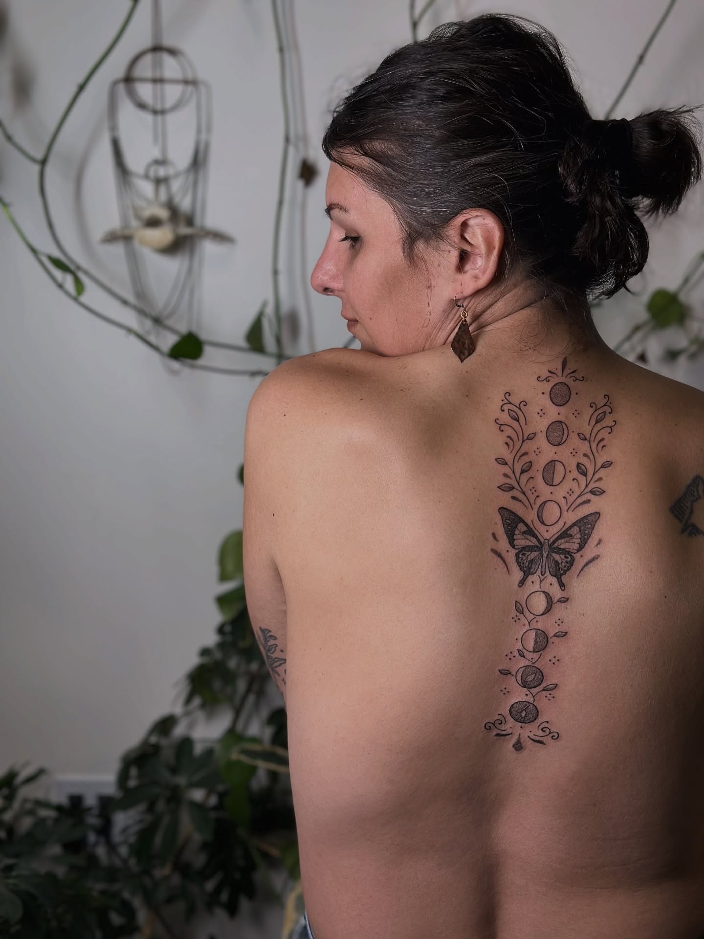 Butterfly and moon phases black and grey tattoo on the back by Santiago Don, Portland, Oregon