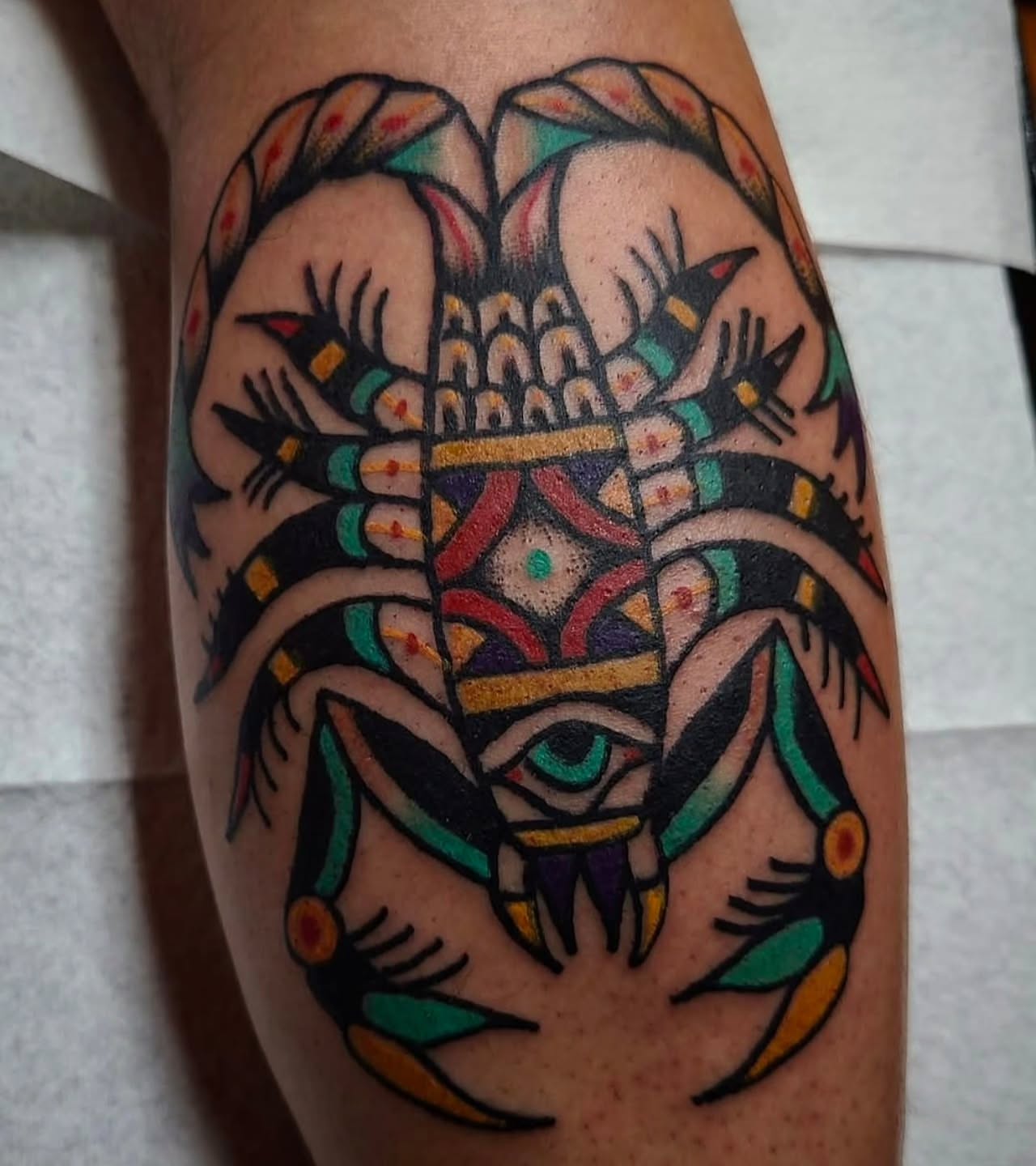 Mask American traditional tattoo on the forearm by Mitch Braver