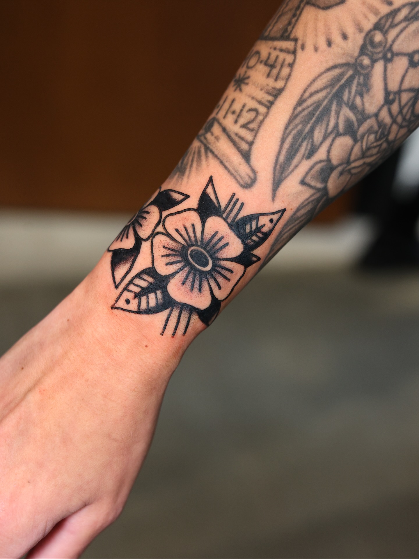 Flower American traditional tattoo on the forearm by Dylan Mott