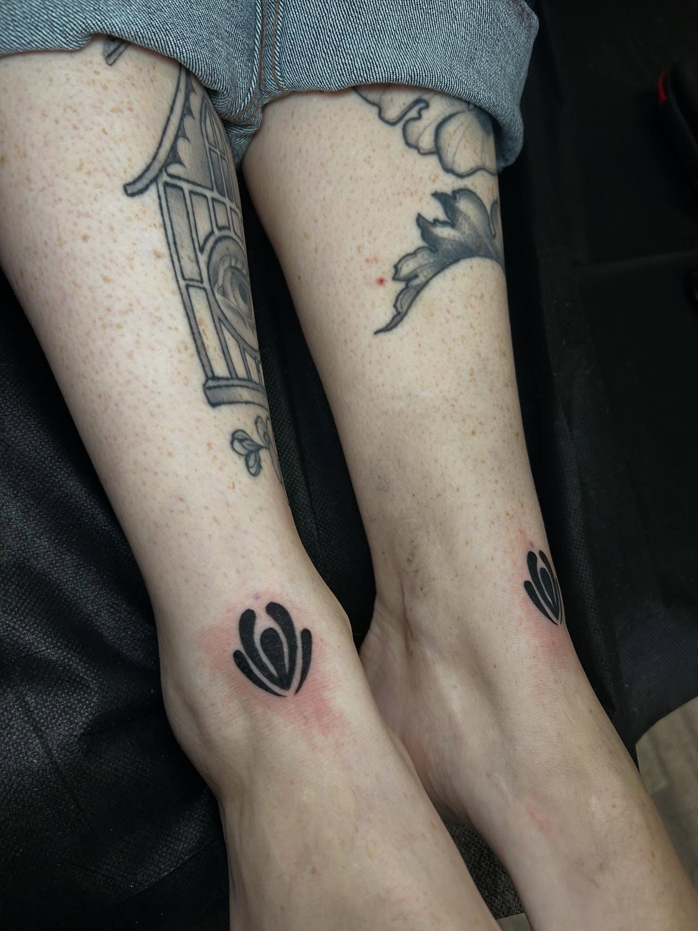 Clock and tulips black and grey tattoo on the forearm by Lily May