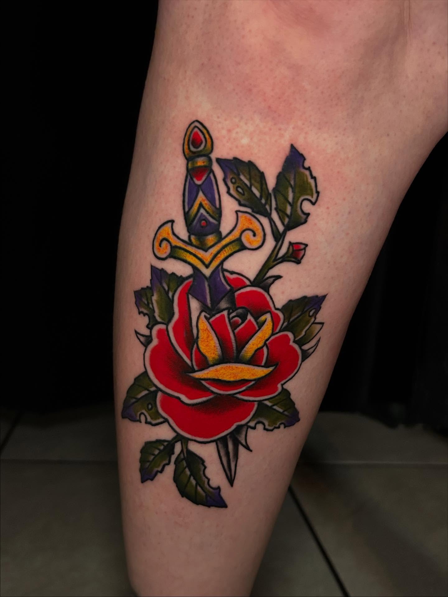 Rose and dagger American traditional tattoo on the forearm by Tim Wilson
