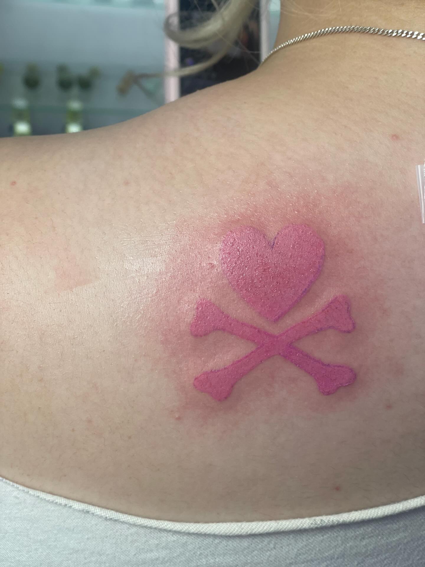 Heart and crossbones geometric tattoo on the back by 😈headhuncho😈