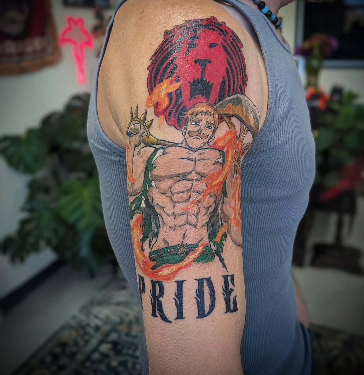 Muscular man with lion illustrative tattoo on the upper arm by 𝕸𝖆𝖉𝖎 (𝕸𝖆𝖉 𝕯𝖔𝖌)