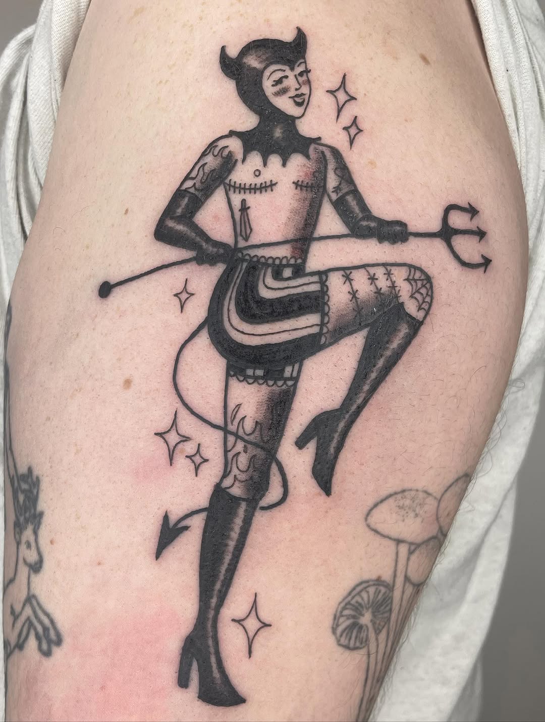 Devil pin-up girl with trident sketch tattoo on the thigh by Fin :