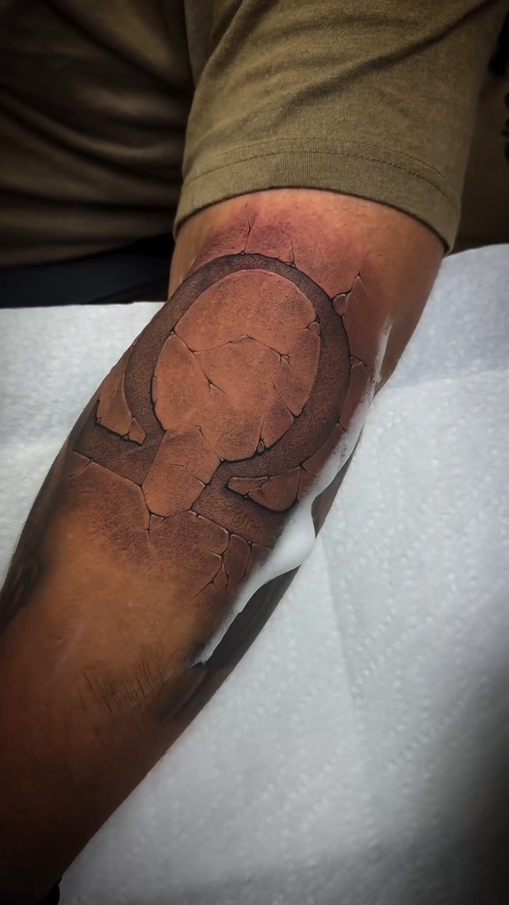 Omega symbol geometric tattoo by Angel Rodriguez