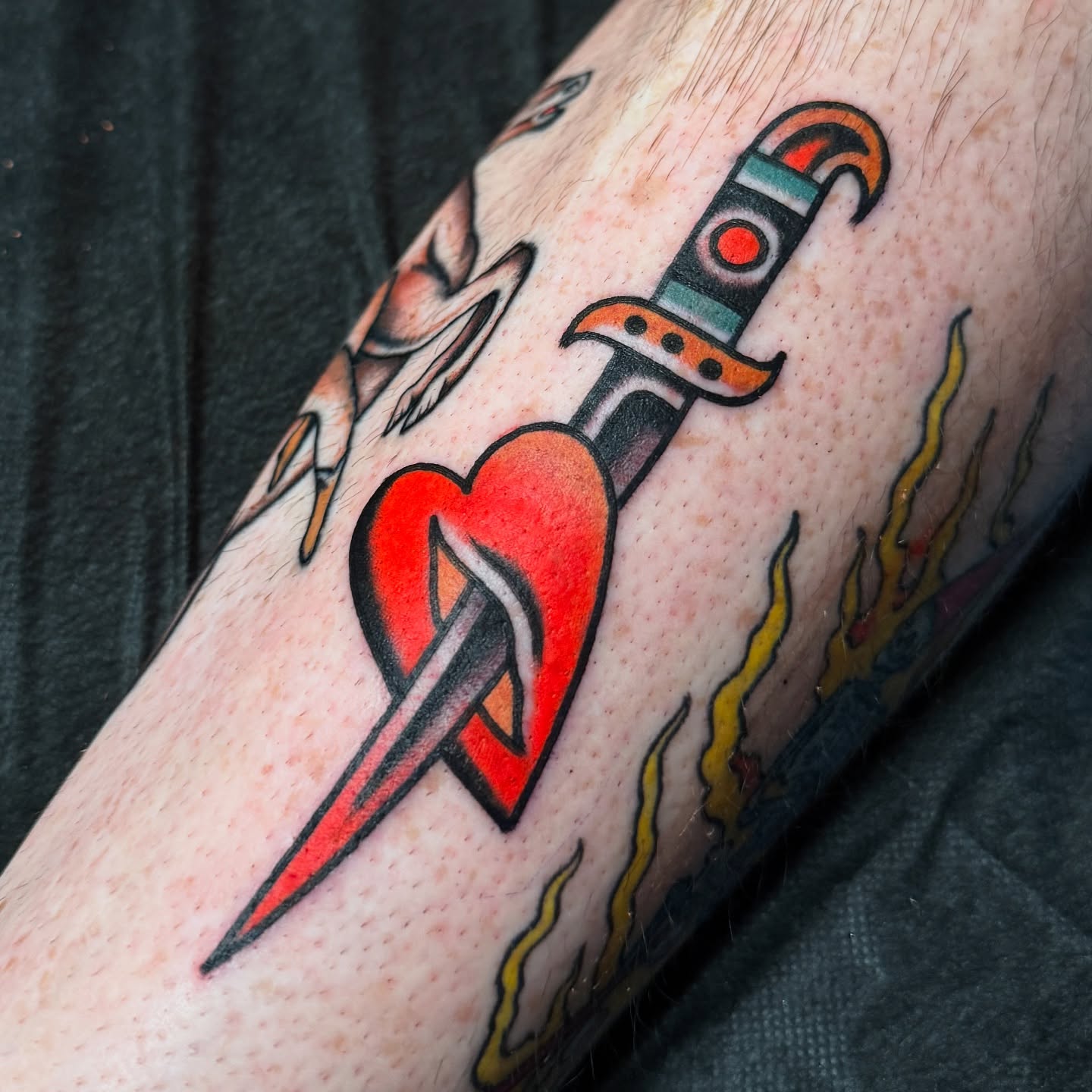 Heart with dagger American traditional tattoo on the forearm by Chaz Otto
