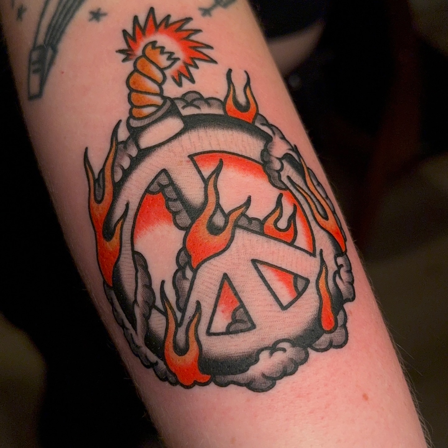 Peace sign American traditional tattoo on the forearm by Chaz Otto