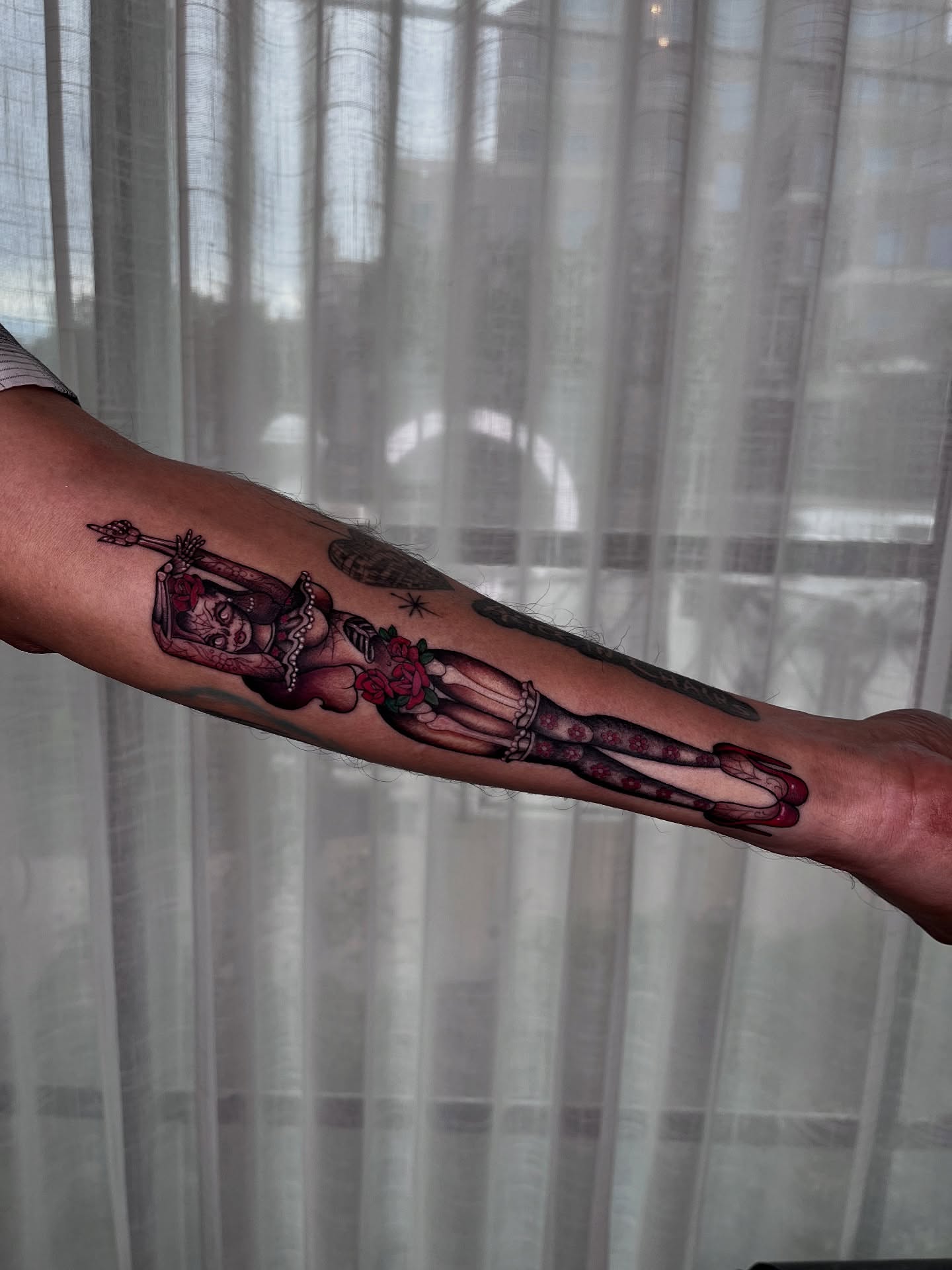 Female figure with roses realism tattoo on the forearm by Kyla Jae