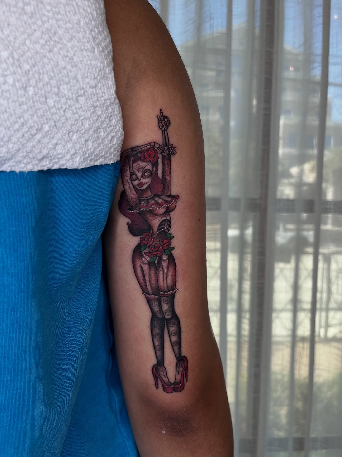 Woman with roses American traditional tattoo on the forearm by Kyla Jae